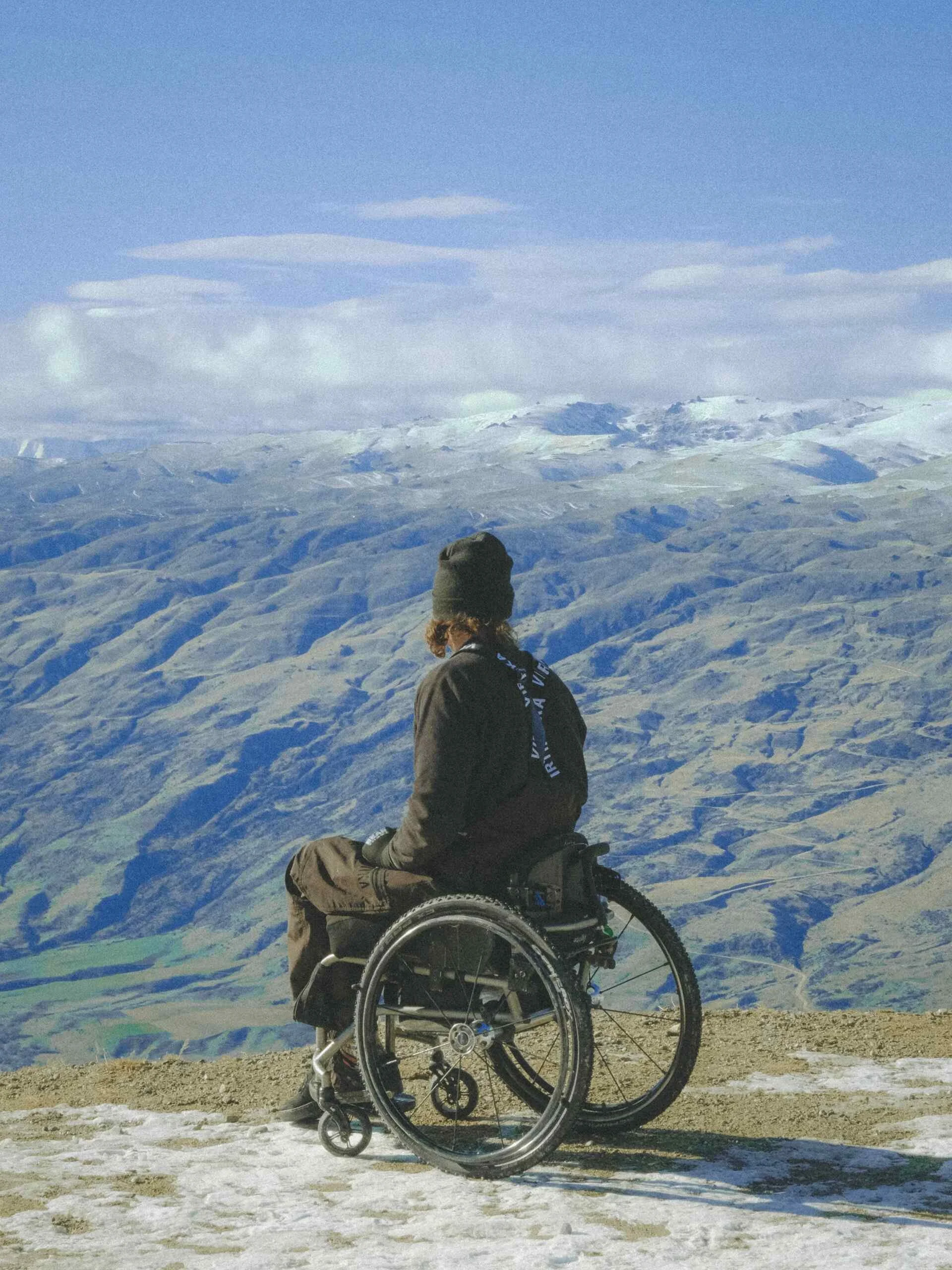 man in wheelchair looking into distance inspiring New Zealand 