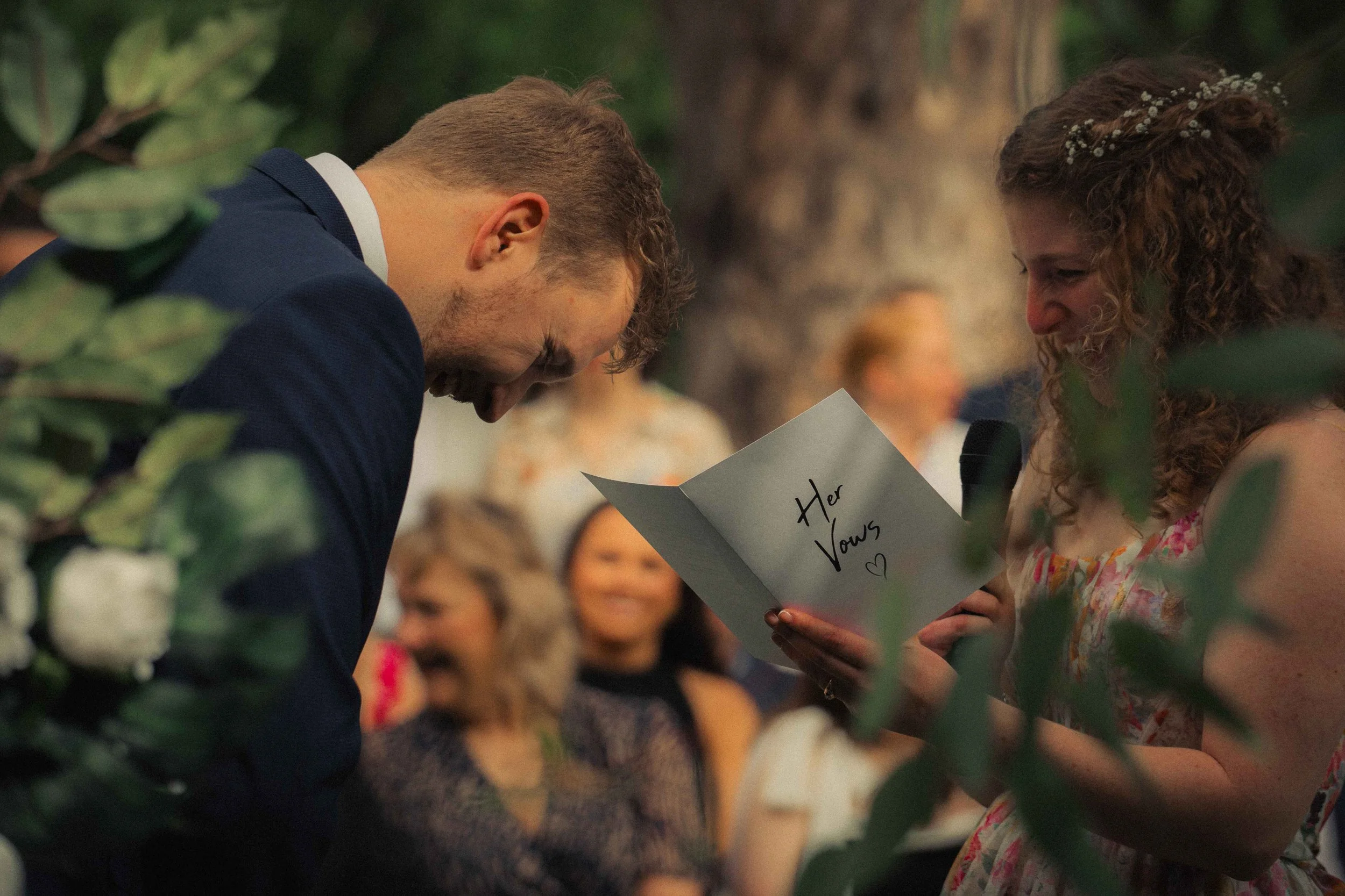 bridge and groom laughing vows colourful bridal dress