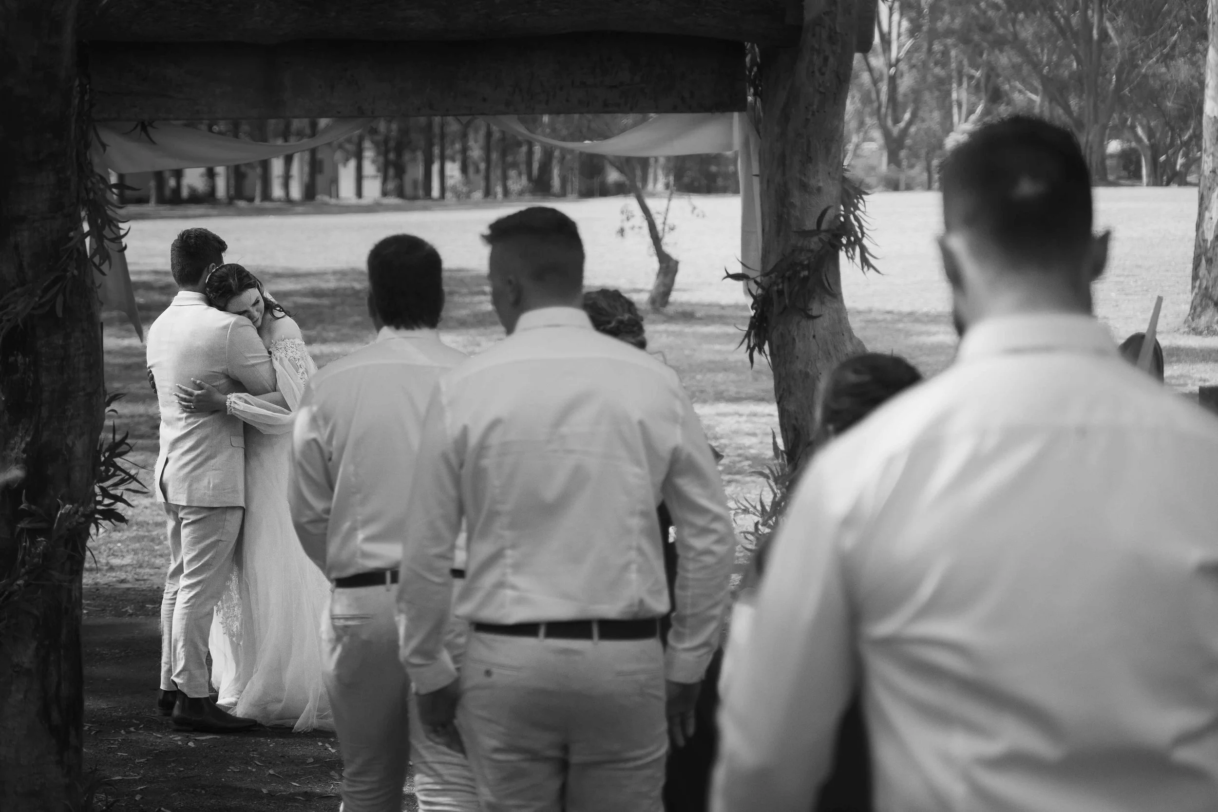 groomsmen and bride emotional hug black and white adelaide hills