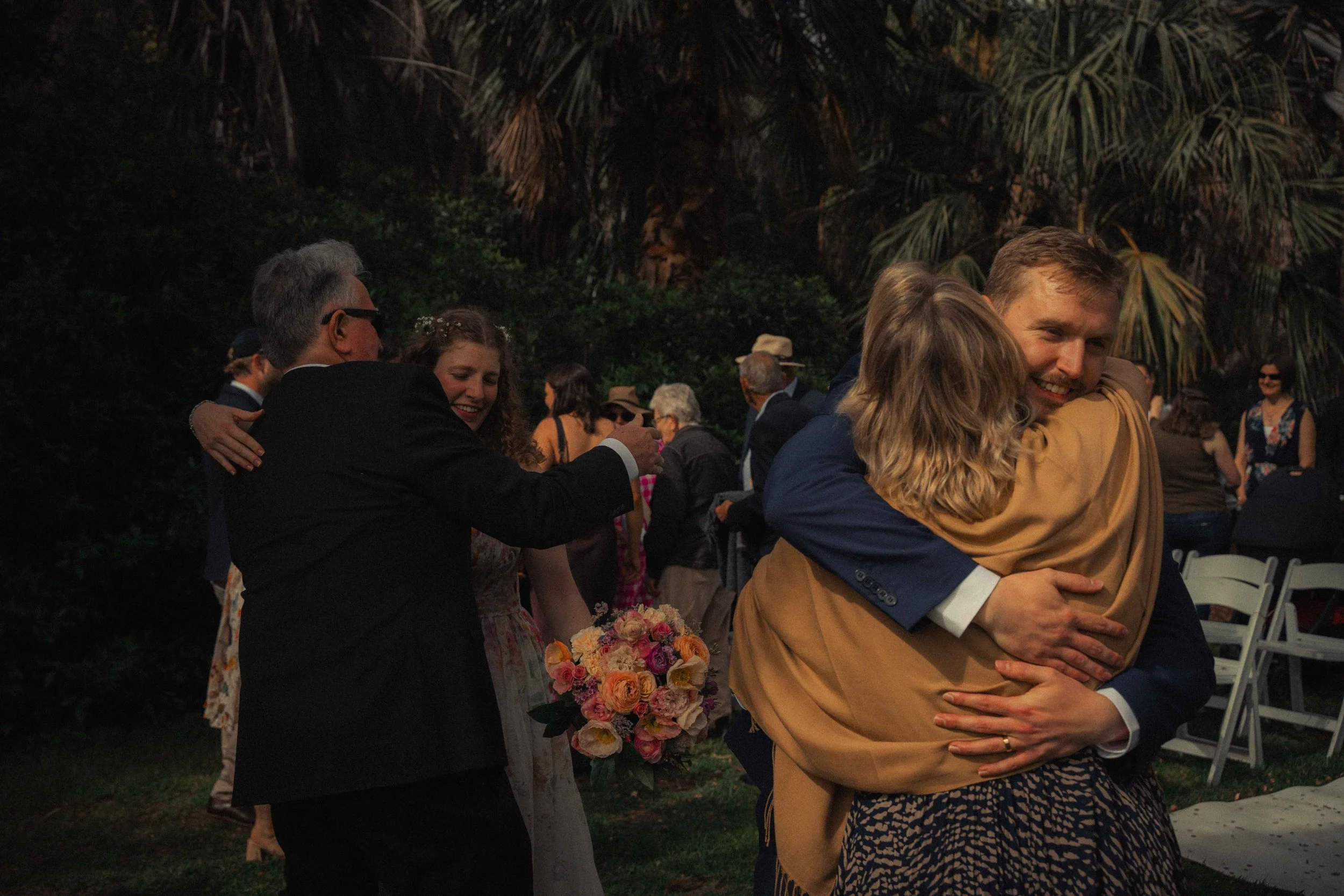 bridge and groom hugging parents Adelaide botanic gardens