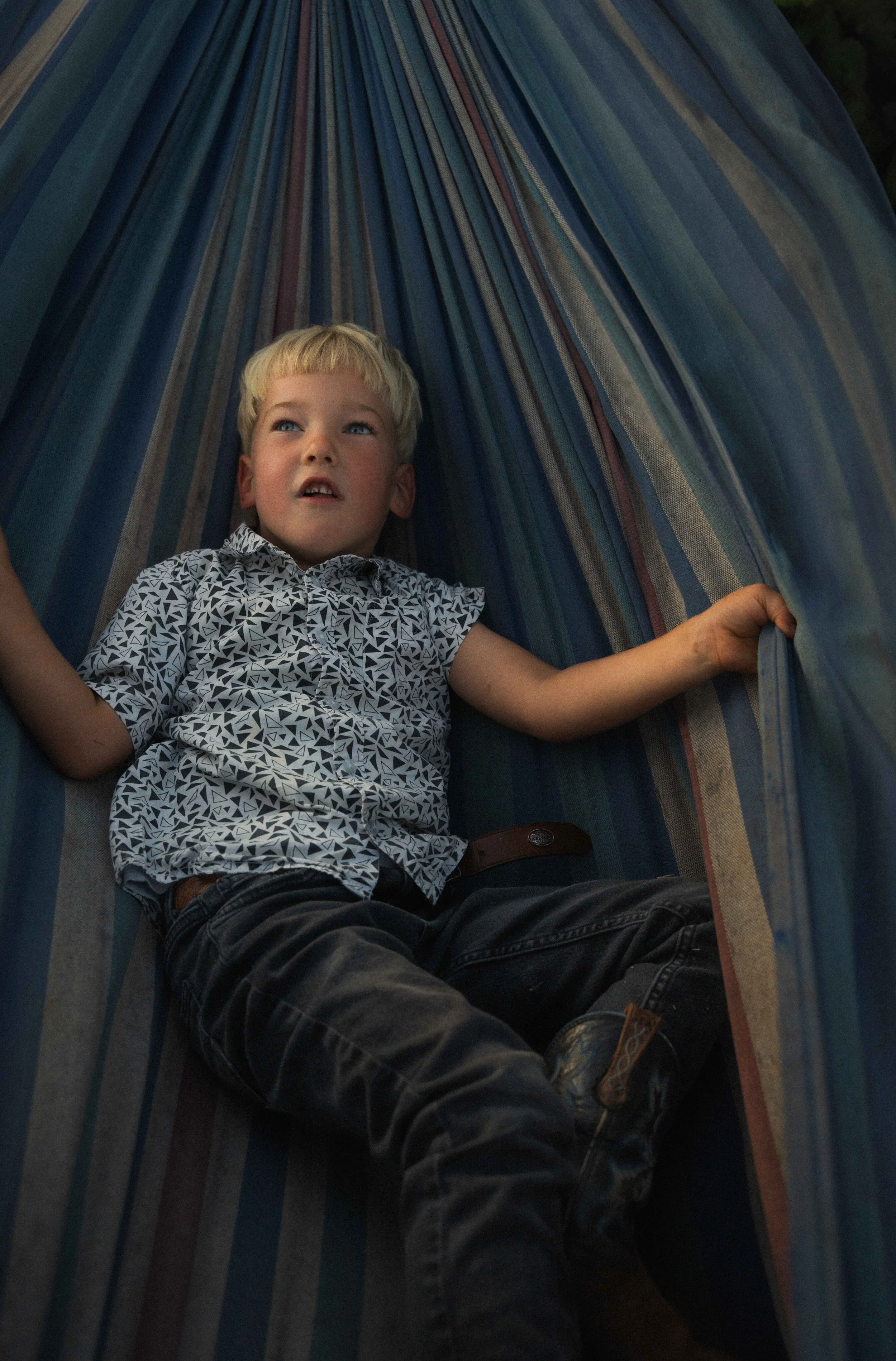 Boy in hammock wedding candid portrait photo