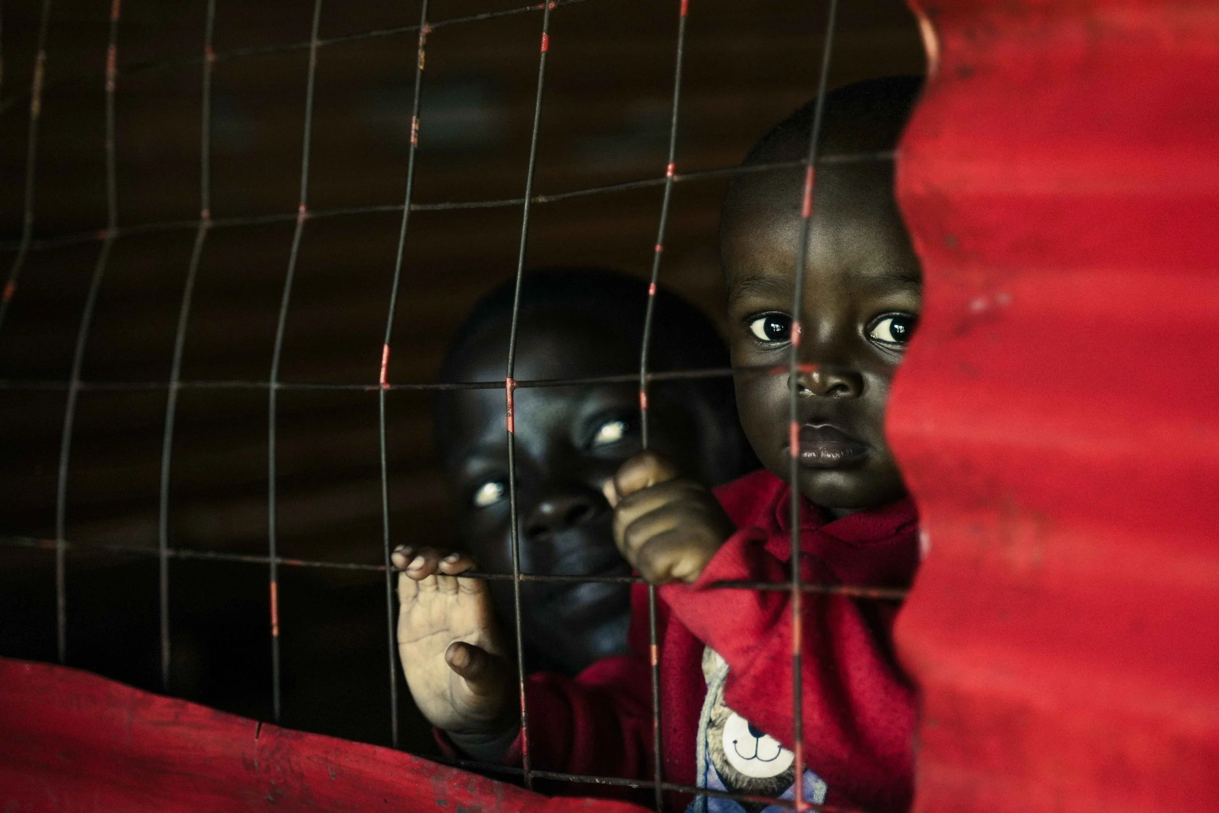 small sad boy behind window Kenya 