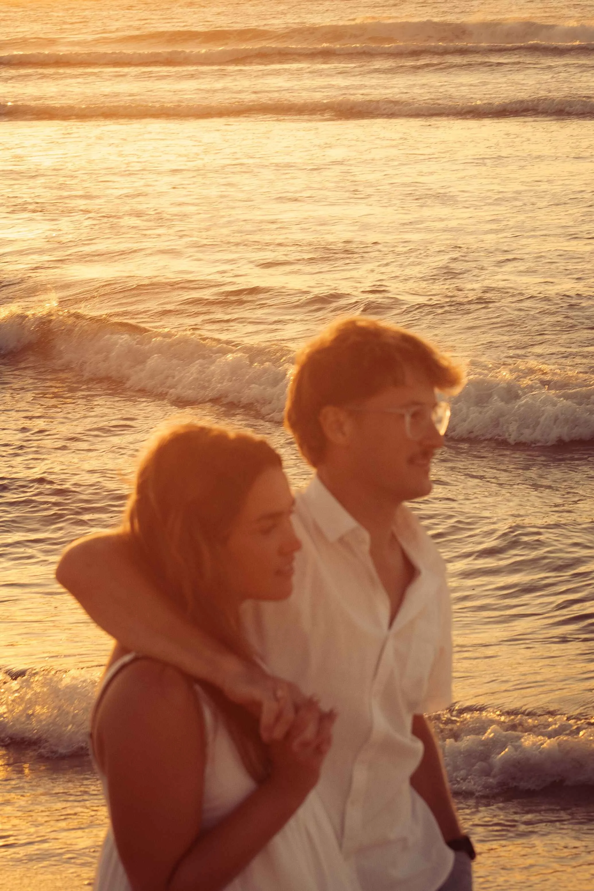 candid engagement photos beach golden hour Noarlunga