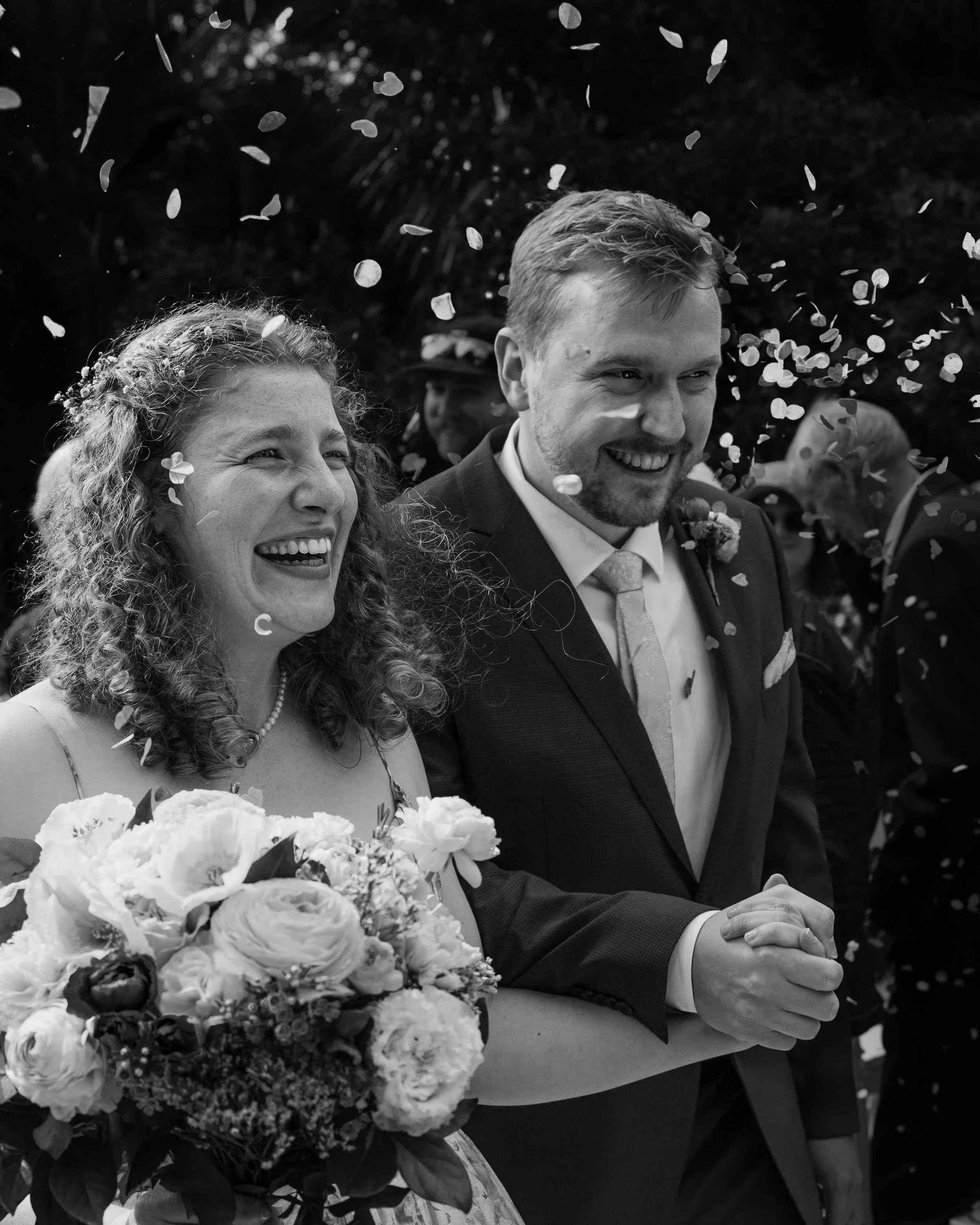 bride and groom smiling petals ceremony 