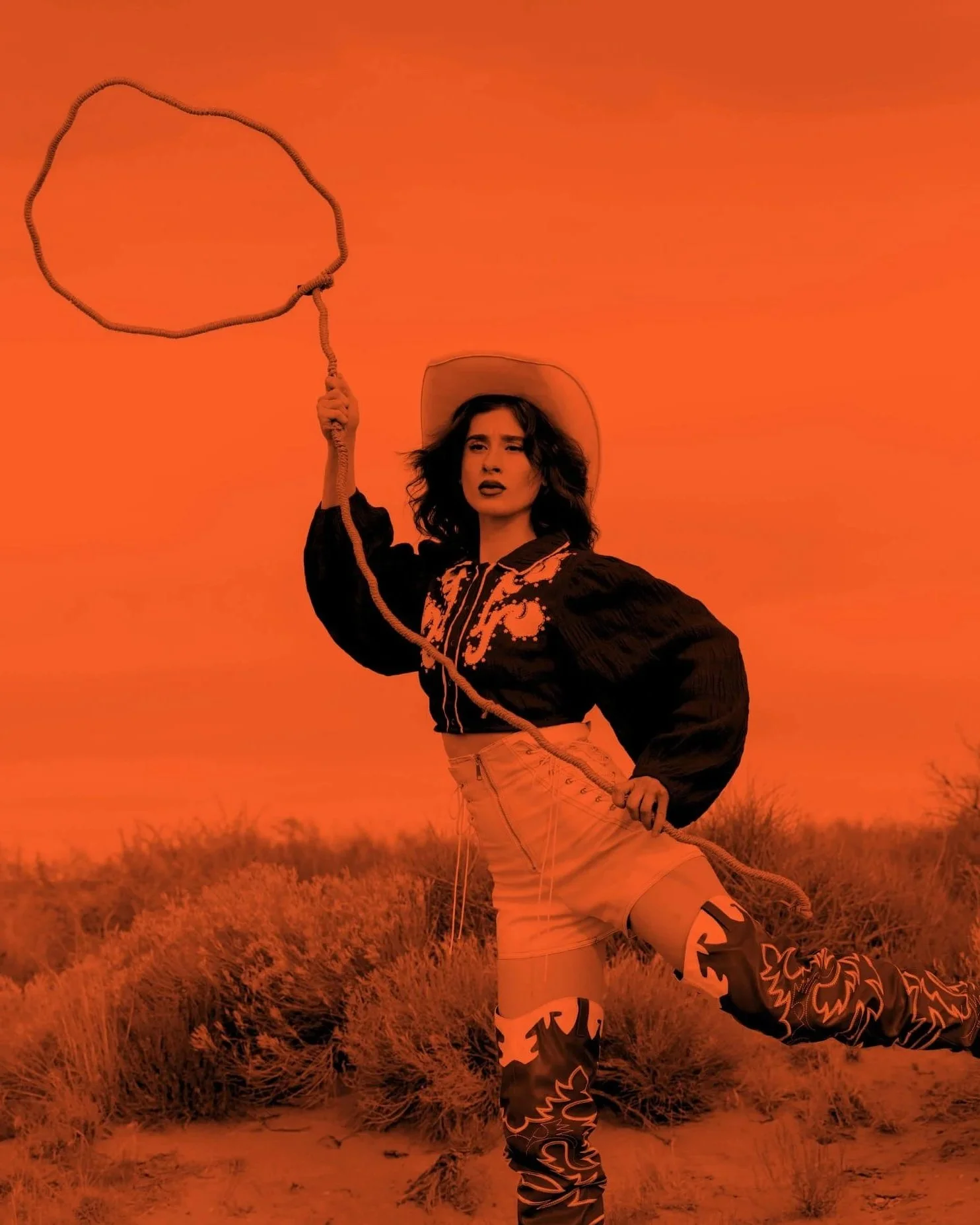 Editorial monochrome image of a woman in western-inspired fashion holding a lasso in a desert landscape, used to represent strategic clarity and marketing direction for Assembl Studio’s Pulse Check service.