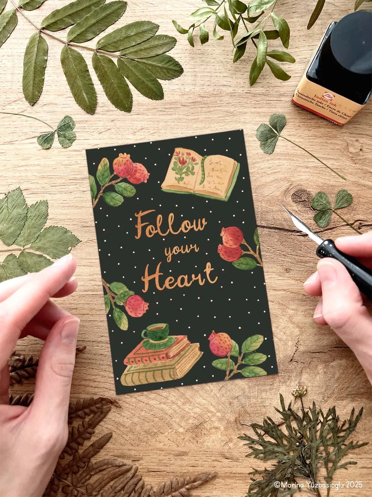 Featuring rose hips, a teacup, stacked books, and hand-lettered text, this card brings a touch of inspiration and seasonal charm to your messages.