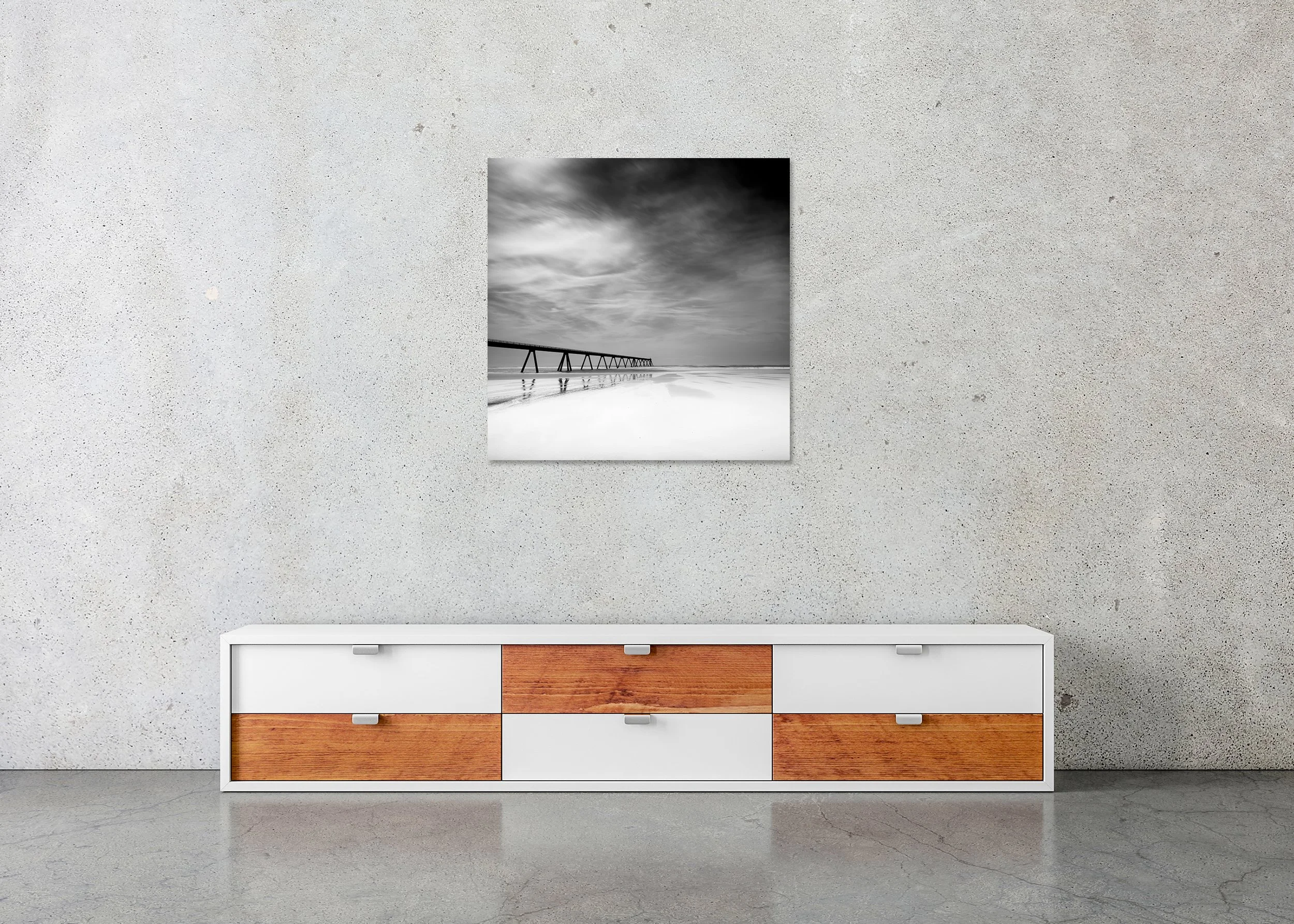 Black-and-white beach photograph with pier, shown as a frameless Dibond wall artwork
