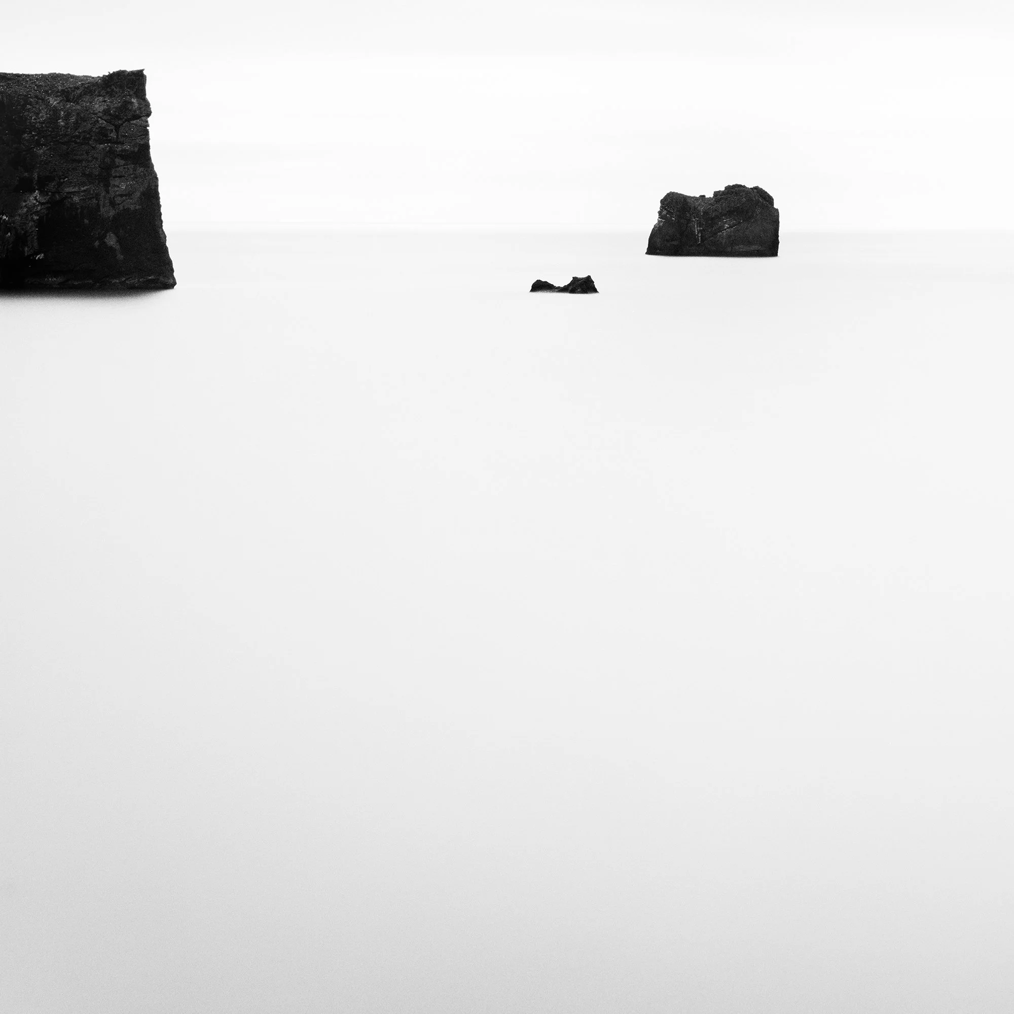 Detail of Black Rocks Study 2 showing dark basalt rock formations in a minimalist Icelandic seascape by Gerald Berghammer.