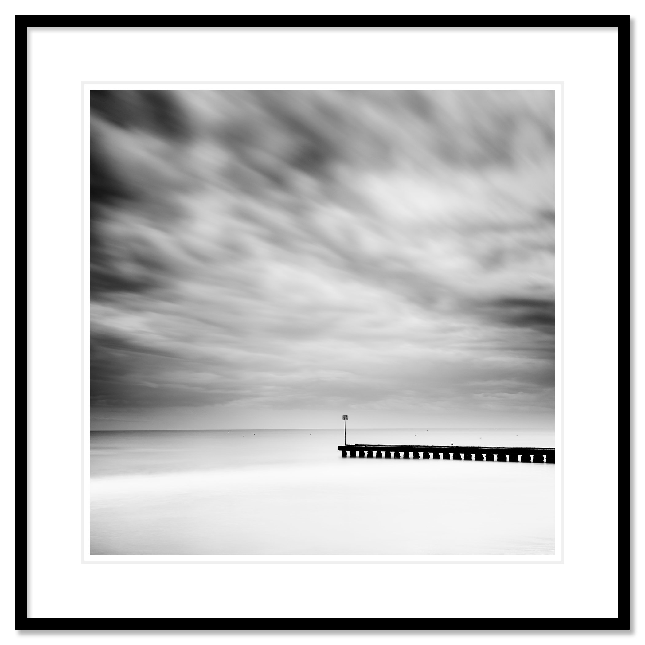 Wooden Pier in the Sea Study 1 – black-and-white fine art photograph from Italy in a black aluminium frame with a white mount by Gerald Berghammer.