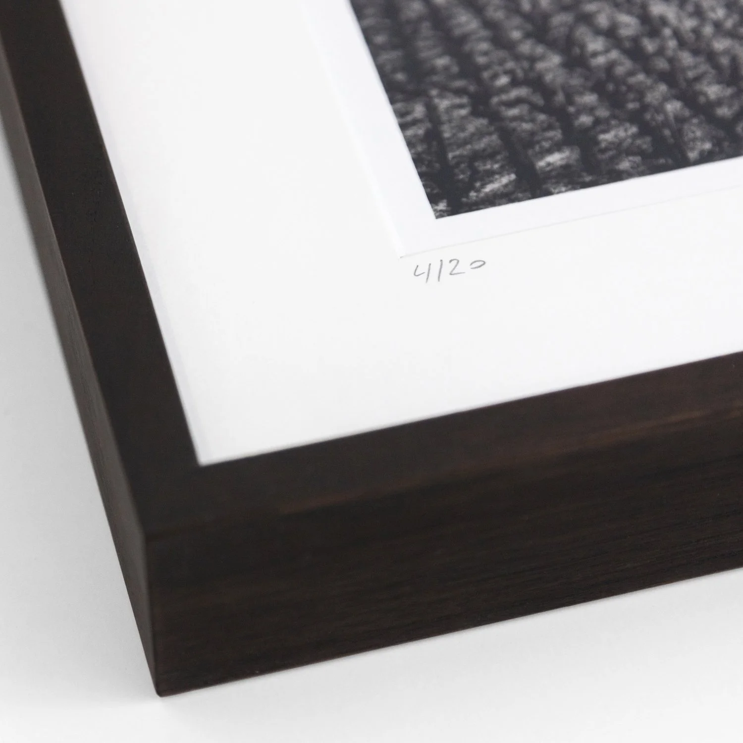 Handwritten edition number 4/20 on Champagne Paradise by Gerald Berghammer, shown alongside the dark-brown wooden frame.