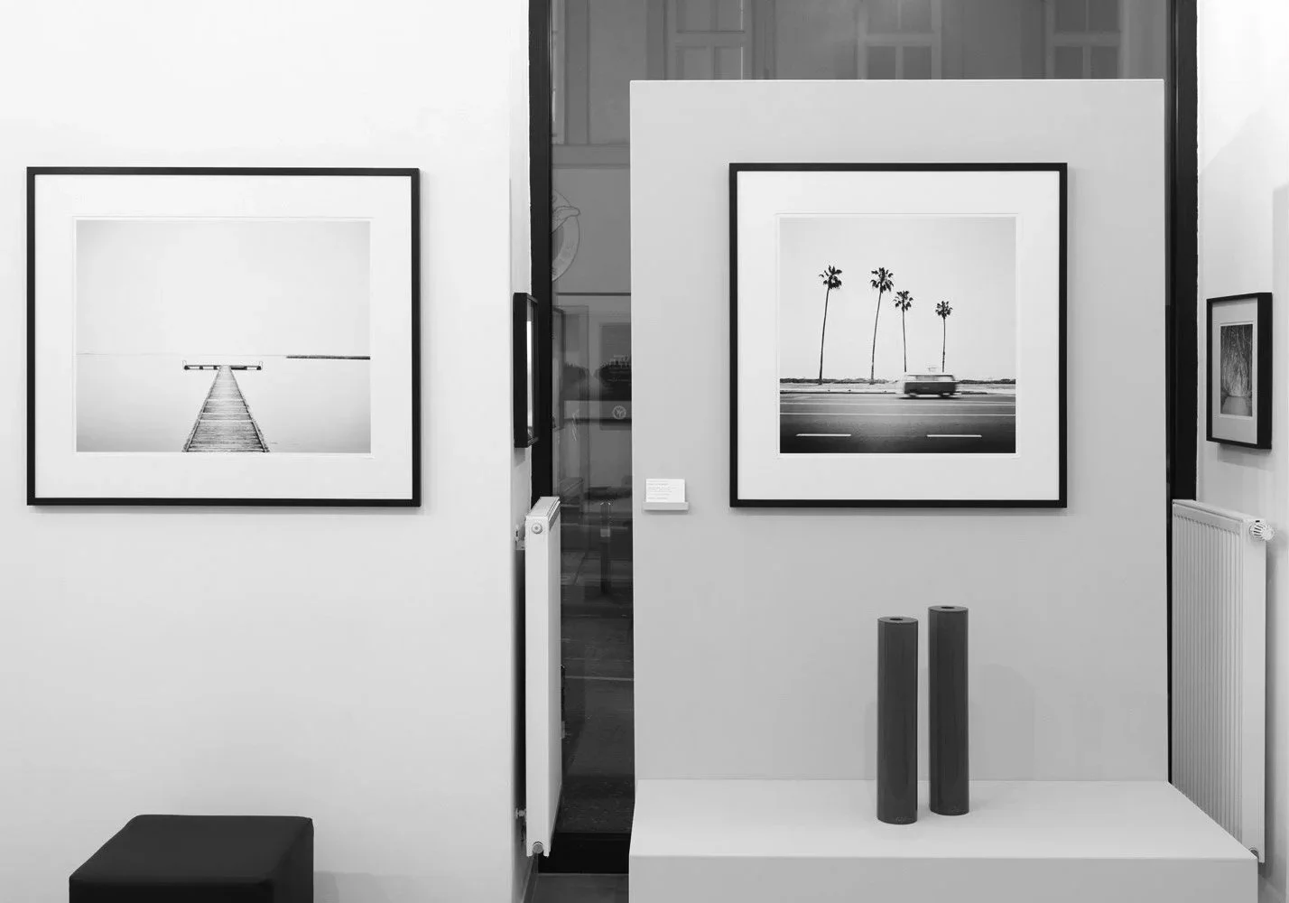 ART AFFAIR II at SILVERFINEART Gallery in Vienna, featuring framed photographs of a minimalist pier and a palm-lined road by Gerald Berghammer.