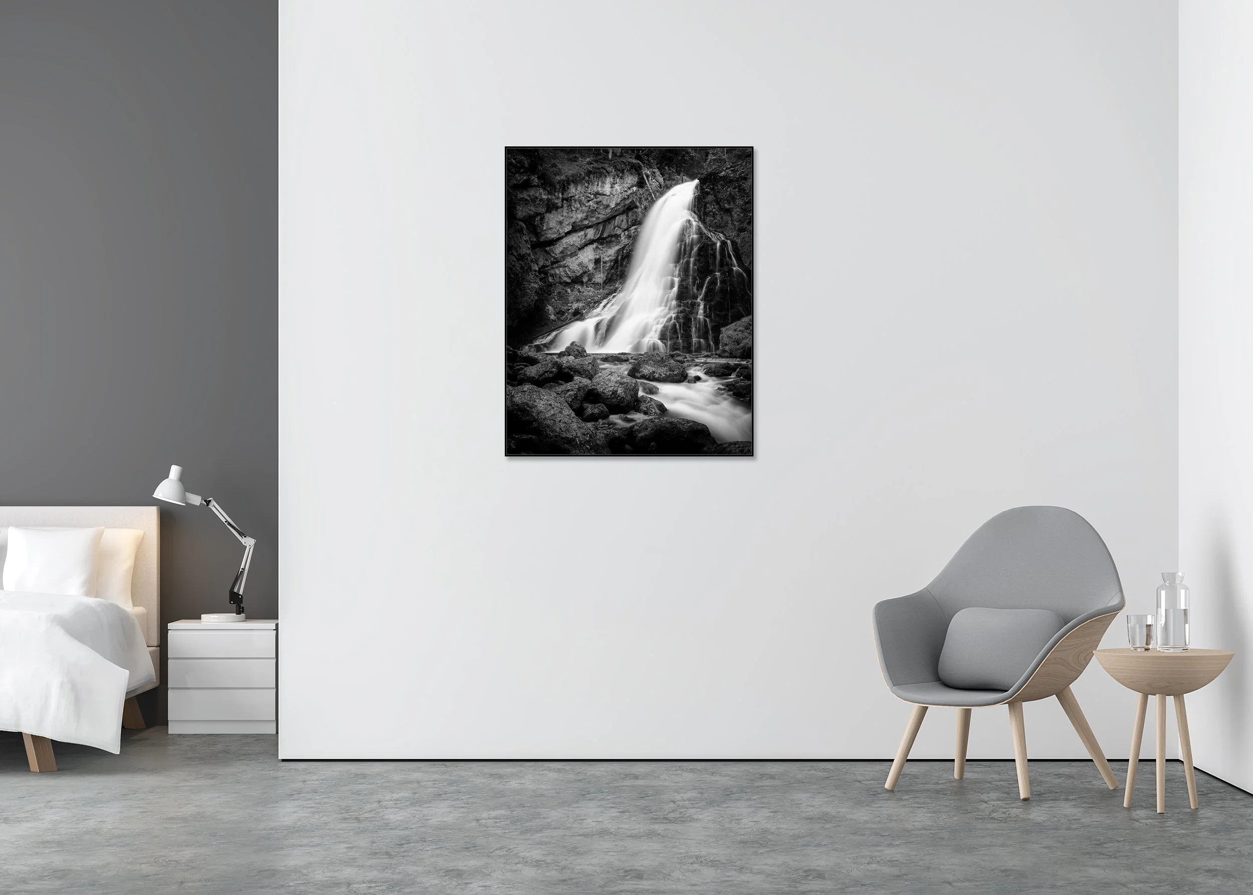 Golling Waterfall black-and-white print in a black aluminium ArtBox, displayed in a minimalist bedroom interior.