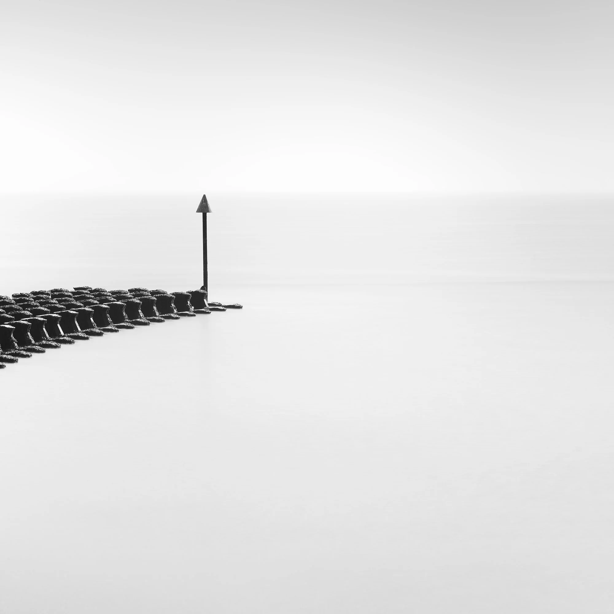 Cobbold’s Point Panorama Study 1 by Gerald Berghammer, black-and-white detail of a solitary navigation marker surrounded by calm sea.