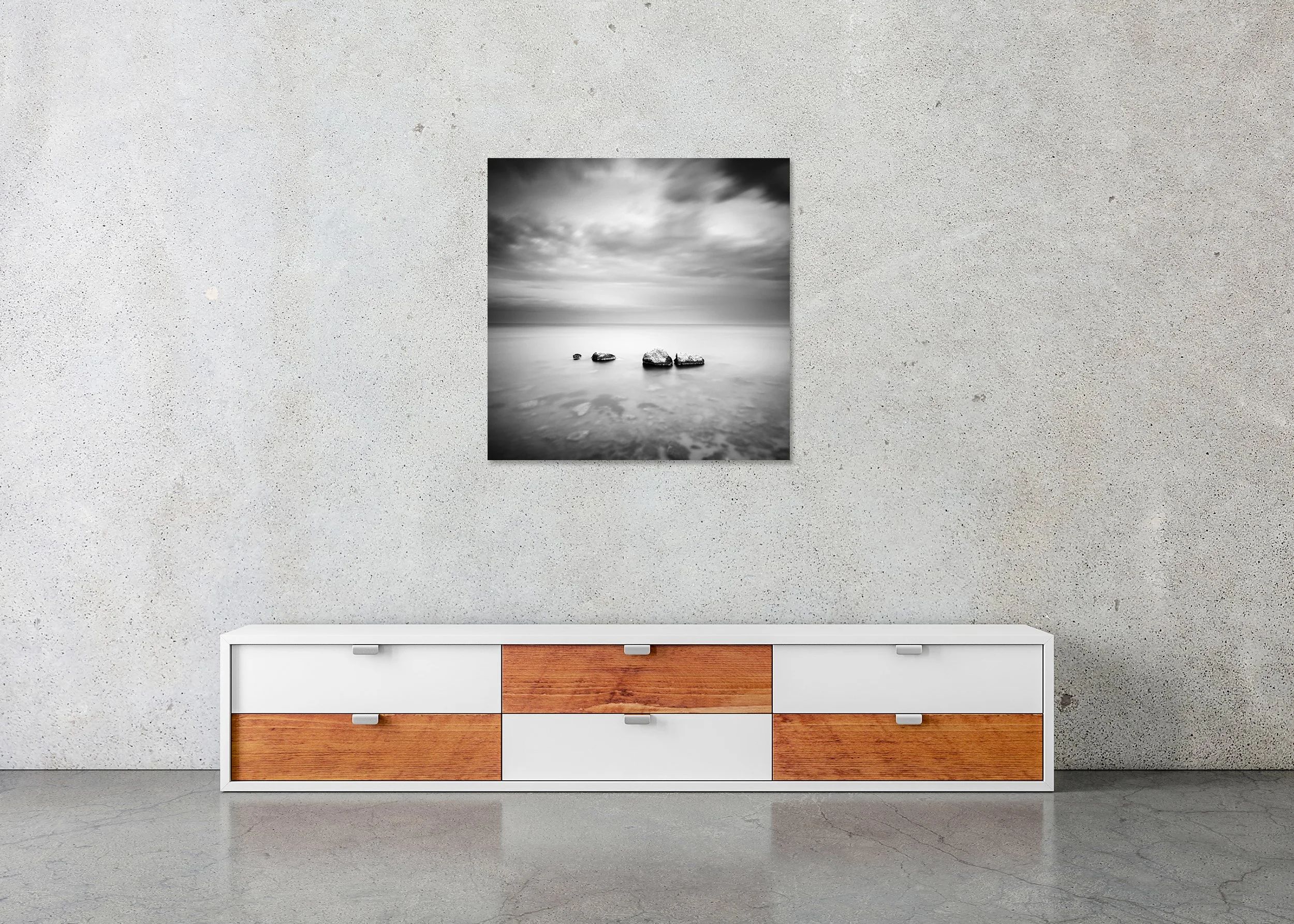 Three and a Half Stone displayed frameless on a concrete wall above a contemporary low sideboard. Photo by Gerald Berghammer