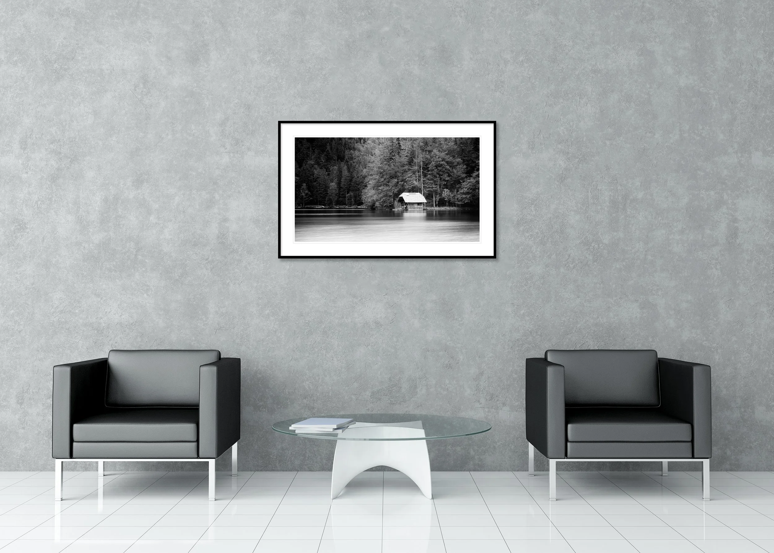 Black-and-white long-exposure of a tranquil lake with a small boathouse by the forest and glassy, calm water; archival pigment print in a classic frame with mount.