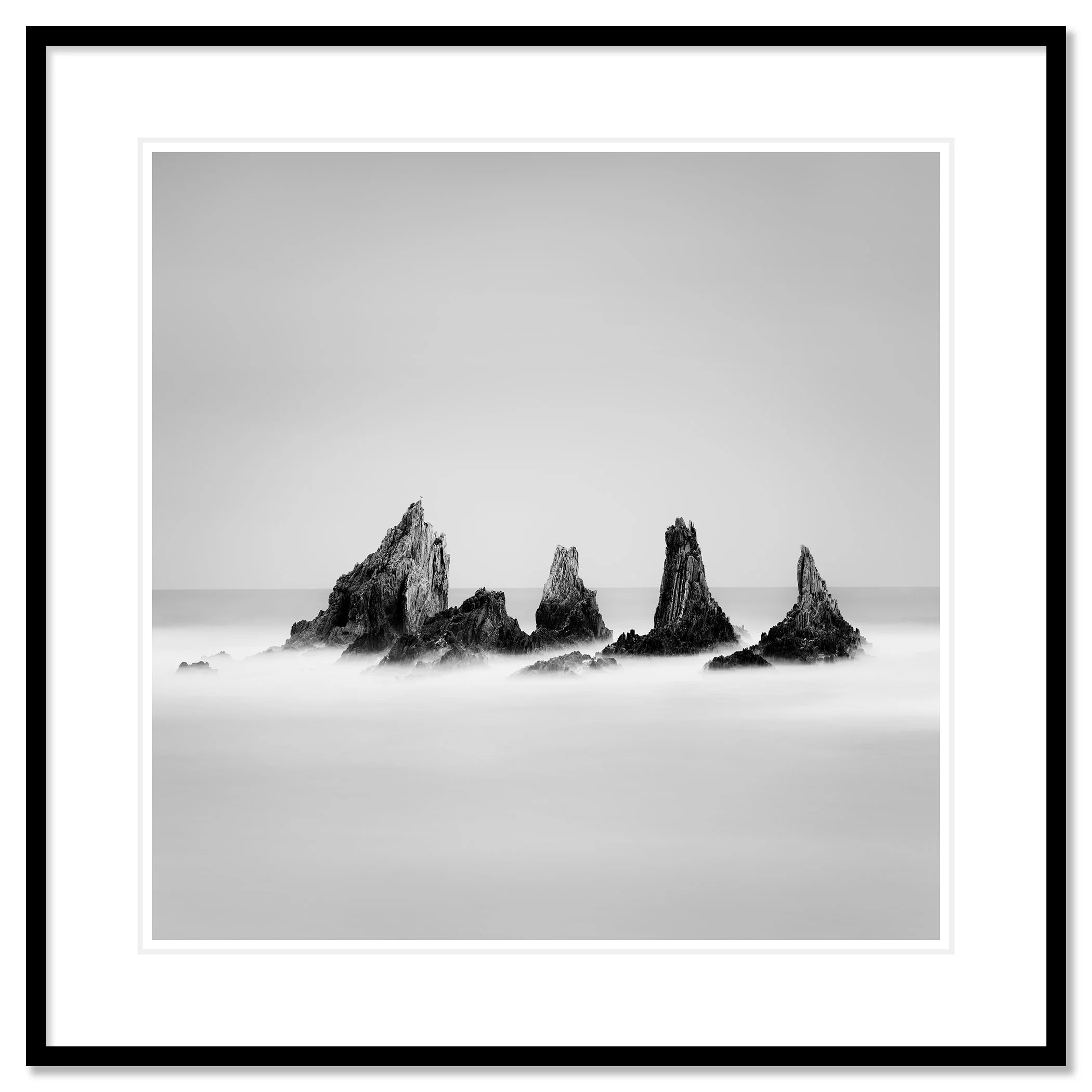 Rocky Peaks Study 1 by Gerald Berghammer, black-and-white seascape presented in a black aluminium frame with a white mount.