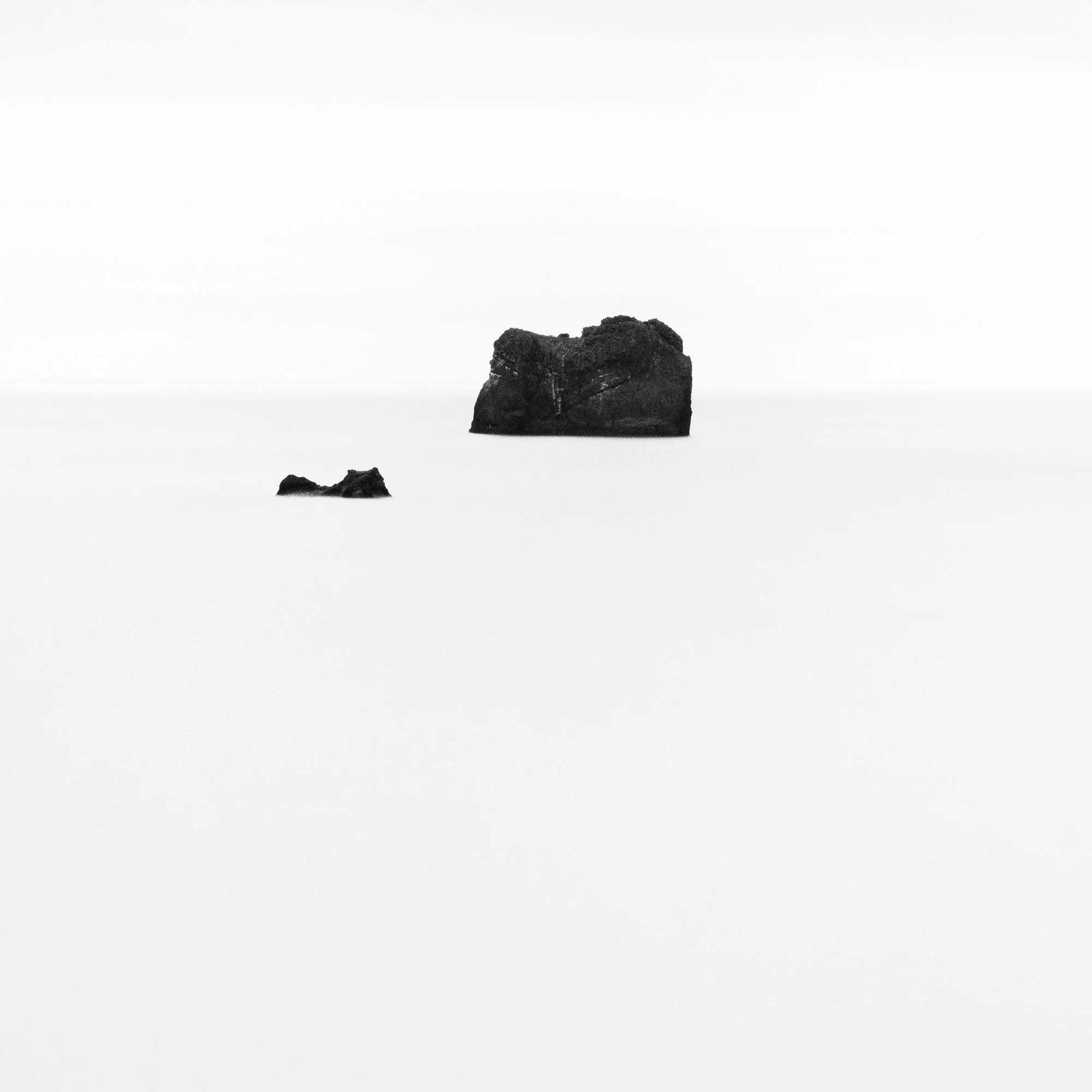 Fine art detail of Black Rocks Study 2 with basalt rocks, soft water and monochrome tones by Gerald Berghammer.