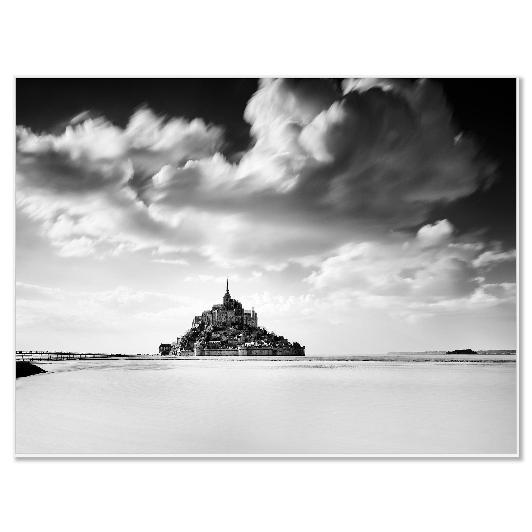 © 2023 Gerald Berghammer - B&W photography. Mont Saint-Michel, a historic island with a tall spire and medieval architecture, surrounded by water and clouds. Chromaluxe framed white