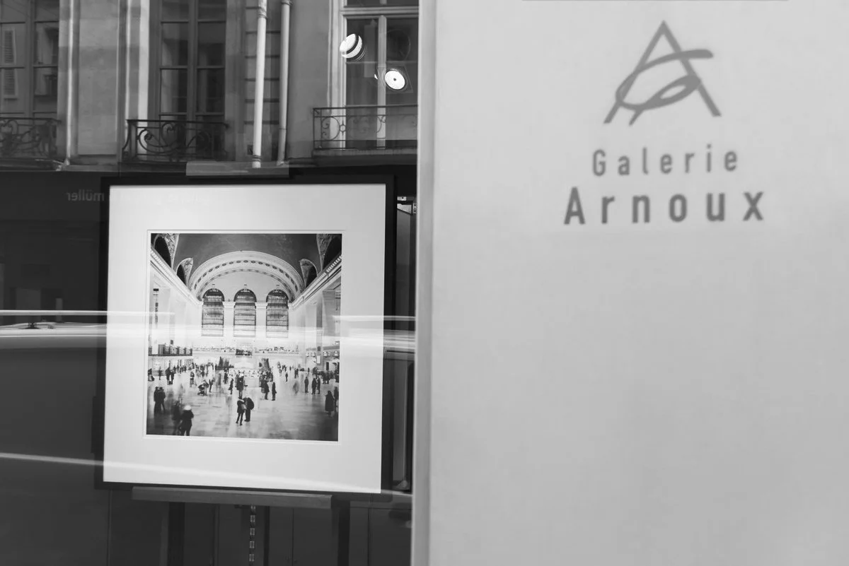 Galerie Arnoux in Paris displaying a framed black-and-white photograph of Grand Central Station by Gerald Berghammer during the 2017 exhibition.