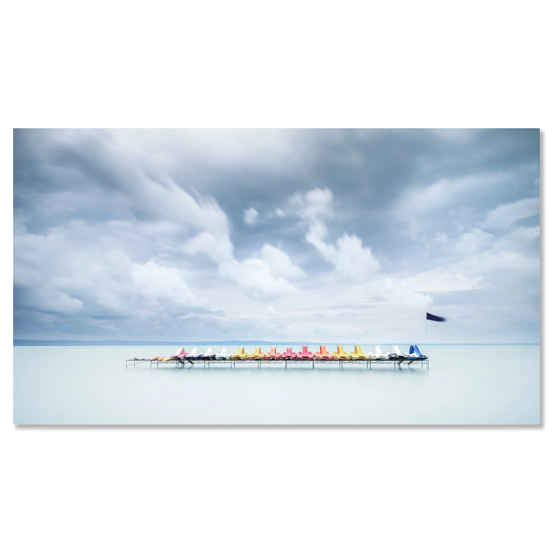 Gerald Berghammer - Color long exposure waterscape photography. Colorful paddle boats lined up on a dock over calm water, under a cloudy sky. Chromaluxe frameless