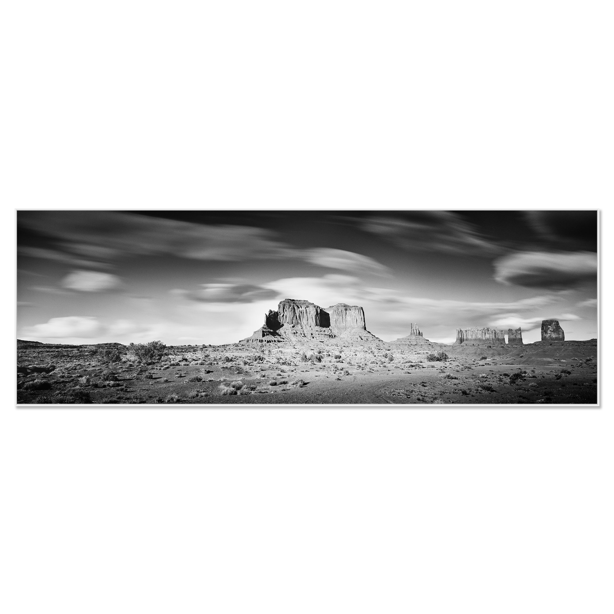 © 2015 Gerald Berghammer - Black and white photography. Landscape of rugged desert terrain with large rock formations and scattered vegetation under a cloudy sky. Chromaluxe framed white