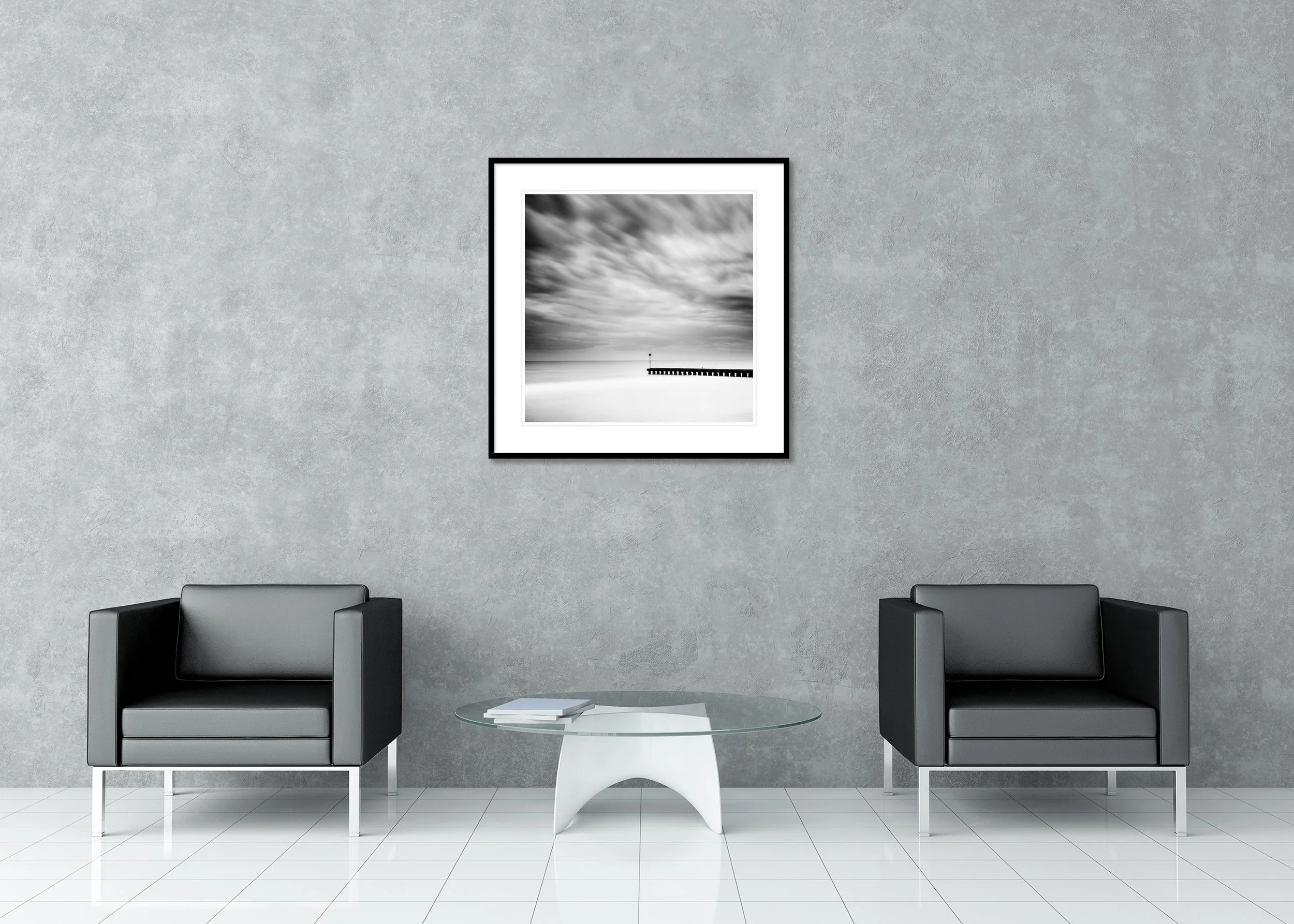 Minimalist black and white beach photo print with blurred clouds and a wooden pier, archival pigment print in a classic frame with mount.