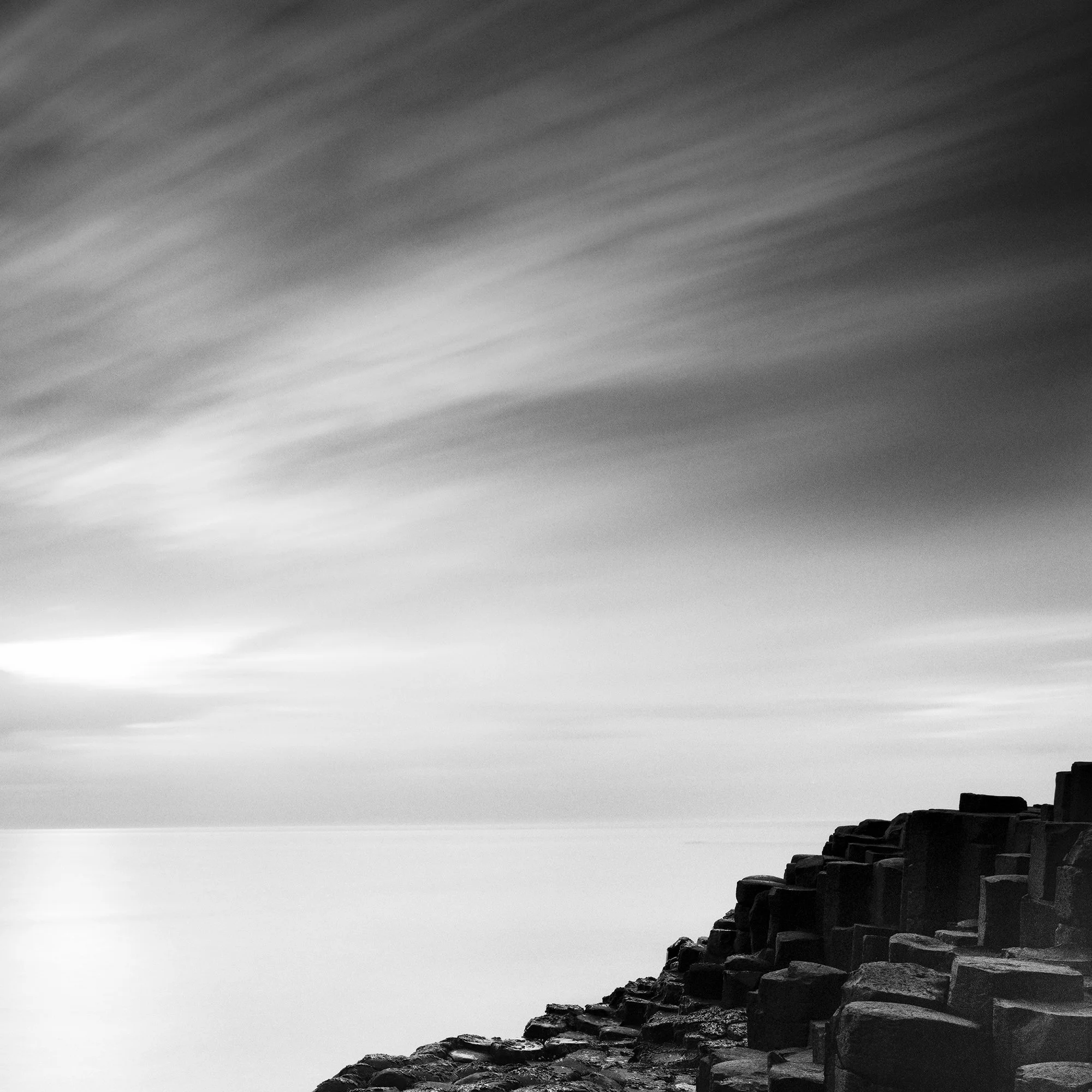 Giant’s Causeway Study 3 by Gerald Berghammer, detail of sweeping clouds above the hexagonal basalt columns of the Giant’s Causeway.