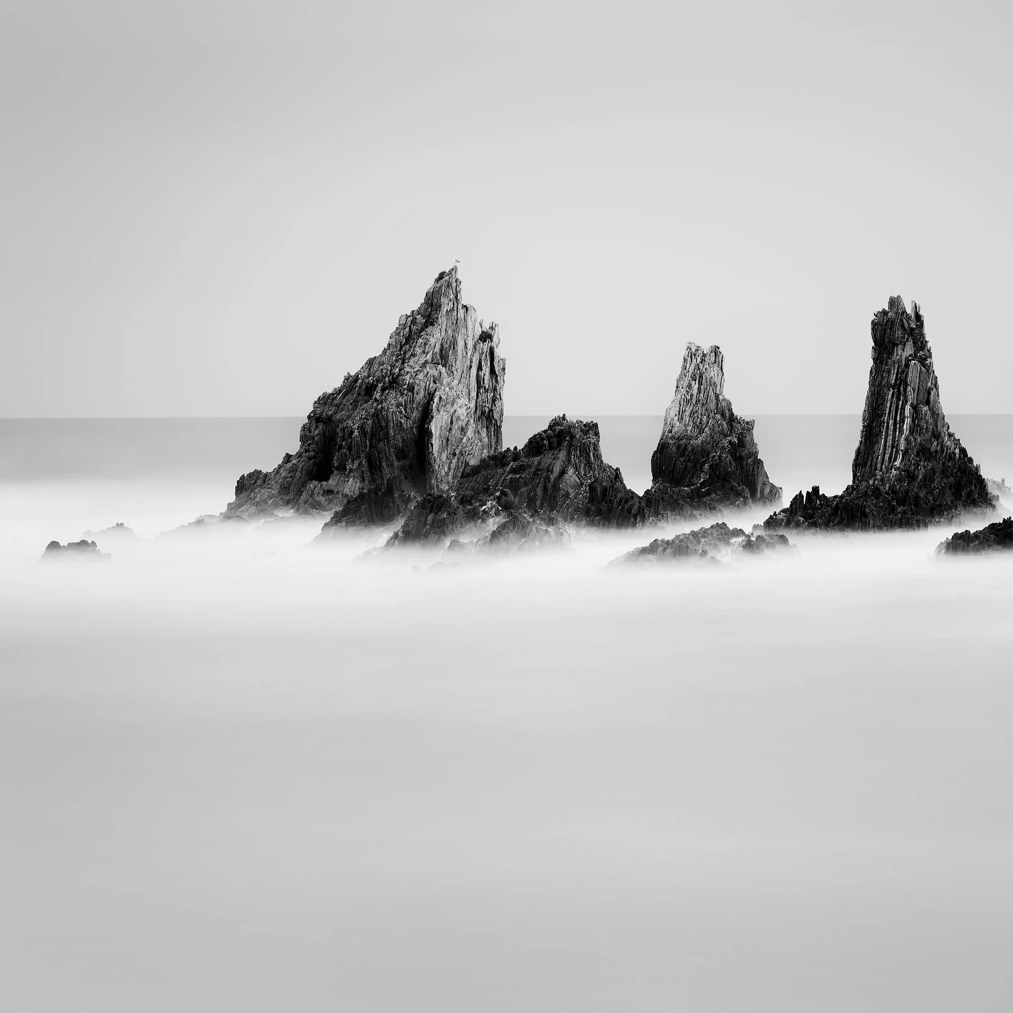 Rocky Peaks Study 1 by Gerald Berghammer, detail view of five rugged sea stacks rising from long-exposure Atlantic water in Spain.