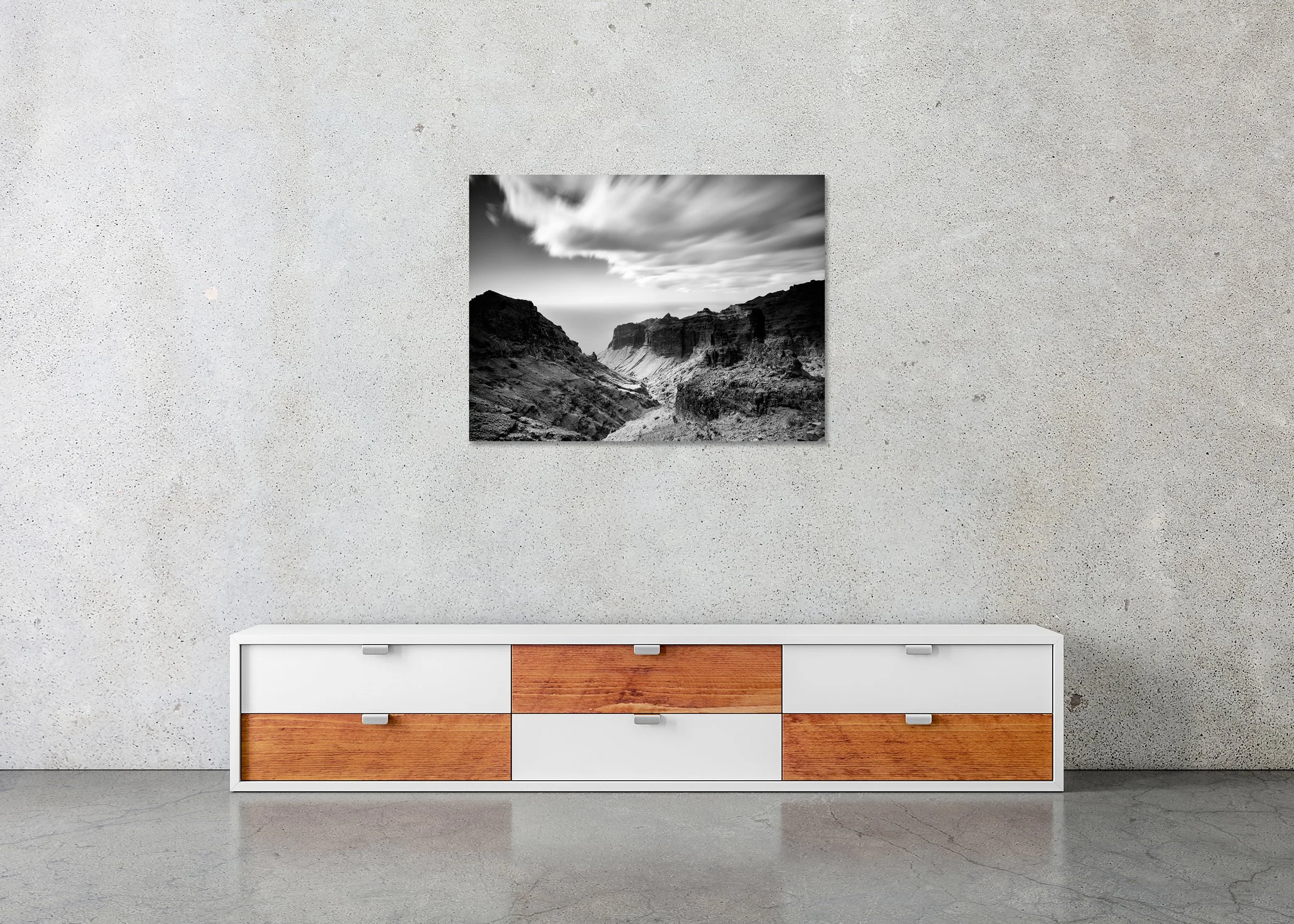 Black and white wall art showing a rugged volcanic ravine leading towards the sea, photo print mounted to Dibond, frameless.