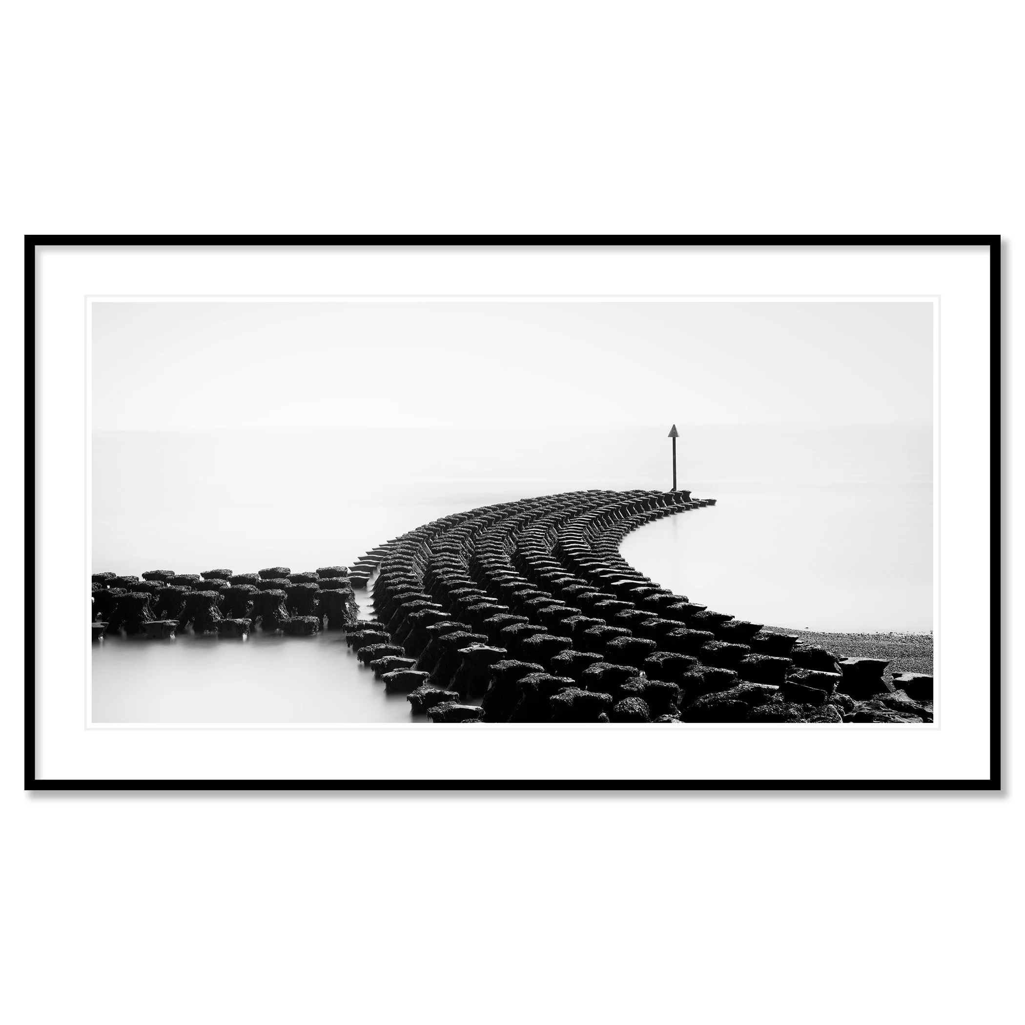 Gerald Berghammer - Black and white minimalist photography. A curved stone jetty extending into a calm body of water, with a tall navigation marker at the end. Classic framed black