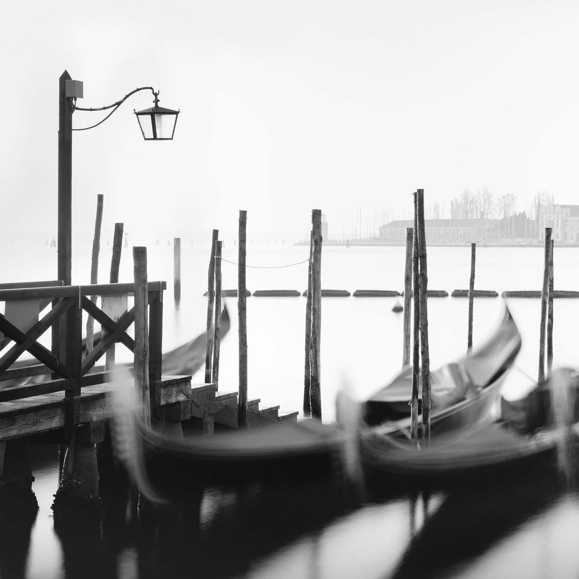 Detail of Twelve Gondolas by Gerald Berghammer showing a Venetian lamp, wooden mooring posts and blurred gondolas during a long exposure.