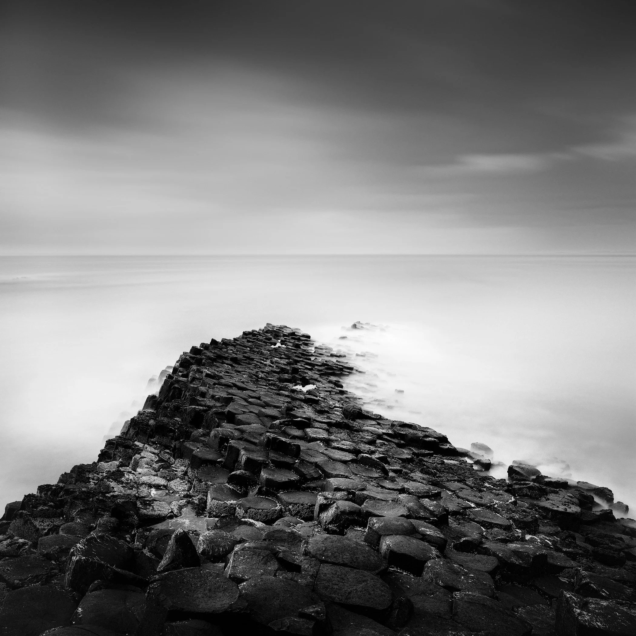 Giant’s Causeway Study 2, black-and-white long-exposure photograph of basalt columns in Northern Ireland by Gerald Berghammer.