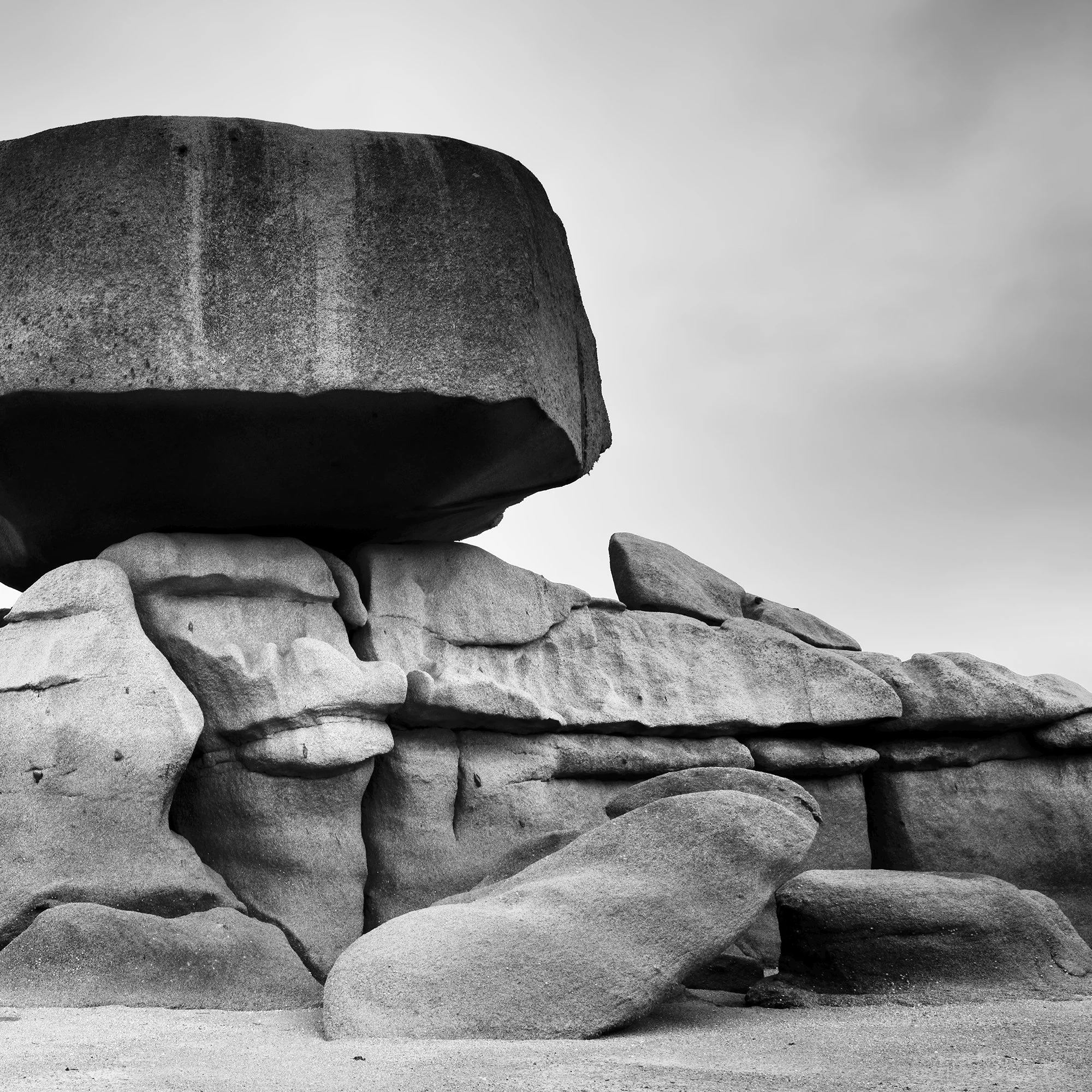 Pink Granite Coast Panorama Study 2 by Gerald Berghammer, close-up of sculptural granite formations beneath a balanced boulder in Brittany, France.