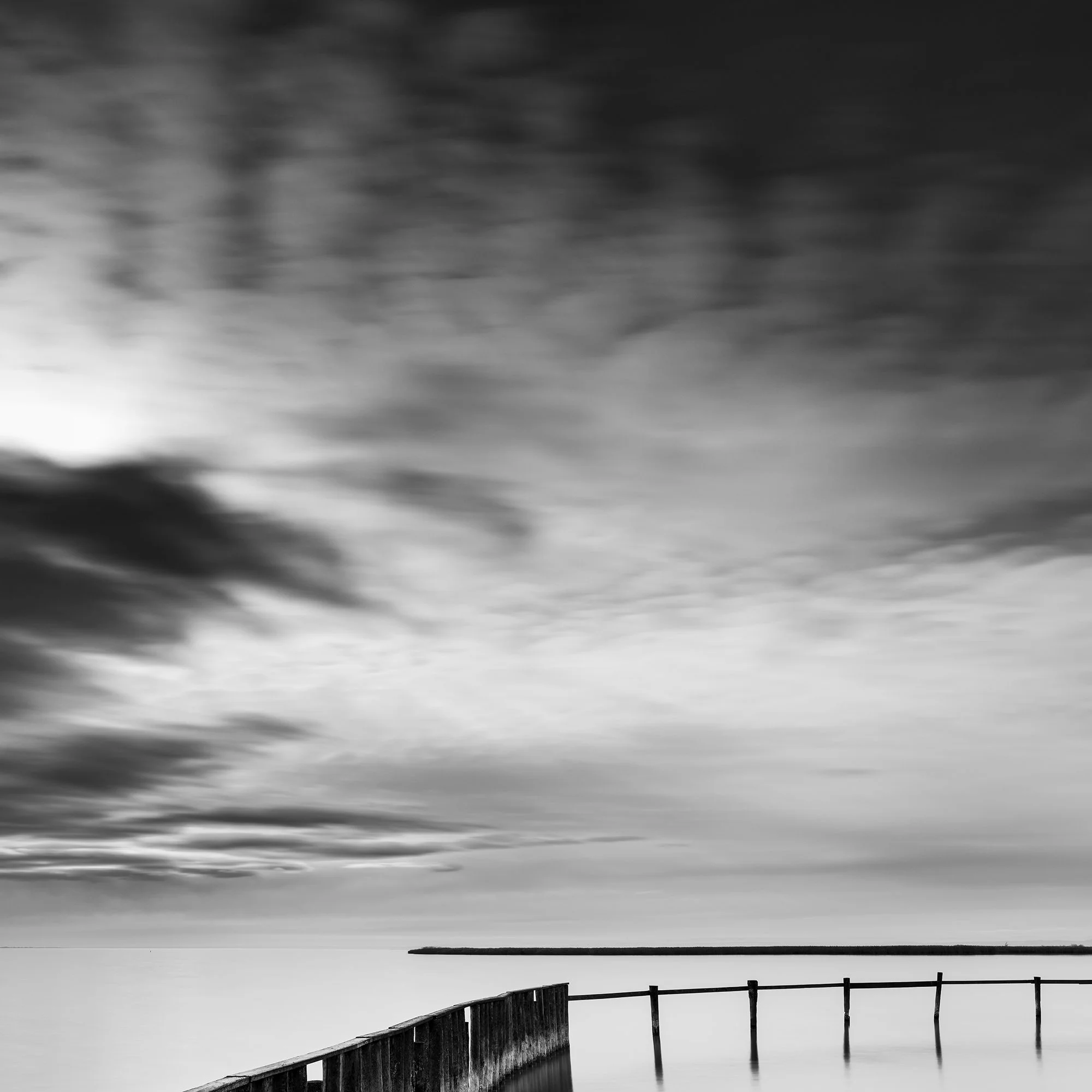 Detail of Swimming Area Study 3 showing the dramatic long-exposure sky and wooden pier at Lake Neusiedl, Austria, by Gerald Berghammer.