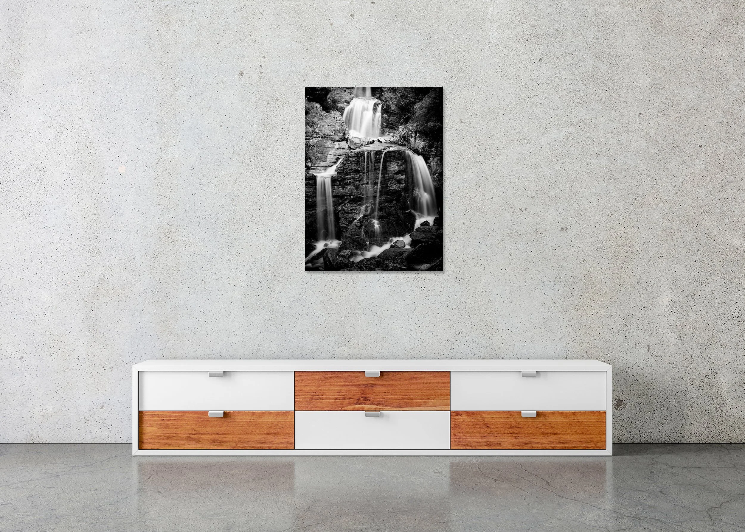 Lower Kuhflucht Waterfall – frameless black-and-white photograph on aluminium Dibond displayed above a low cabinet.