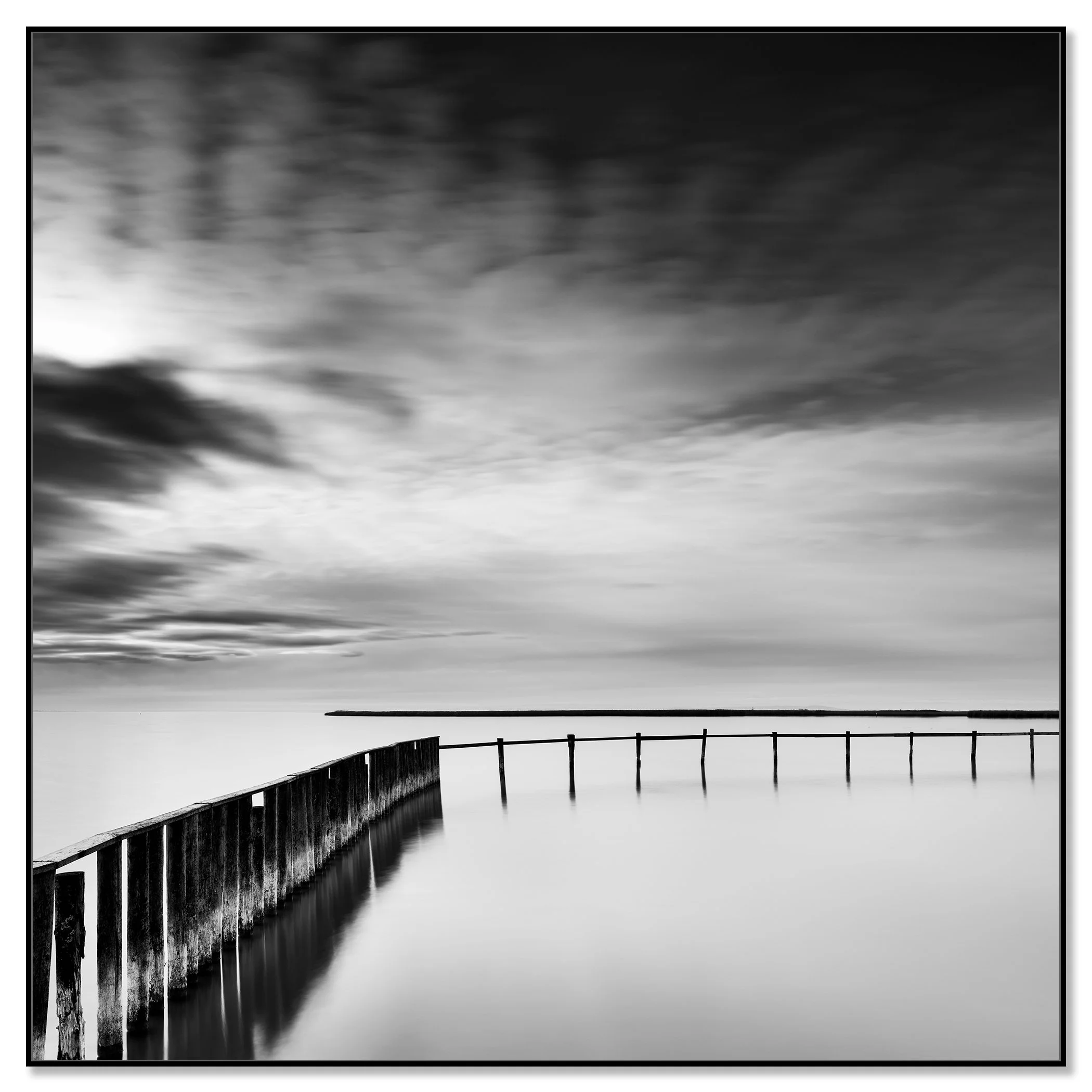 Minimalist black and white landscape with still water and a long wooden jetty – framed ArtBox black