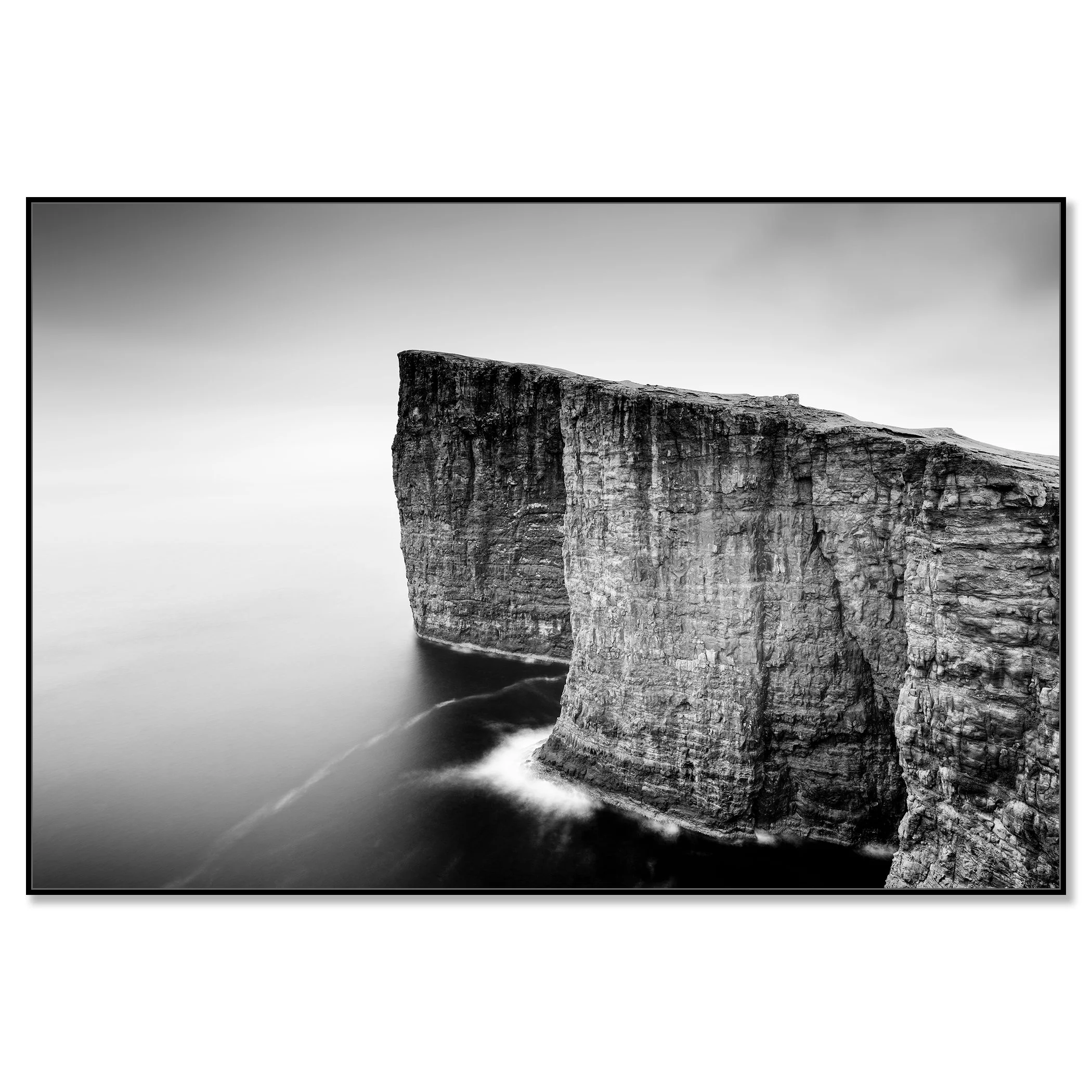 Dramatic Faroe Islands coastline with steep rock cliffs, soft sea mist and calm water – framed ArtBox black