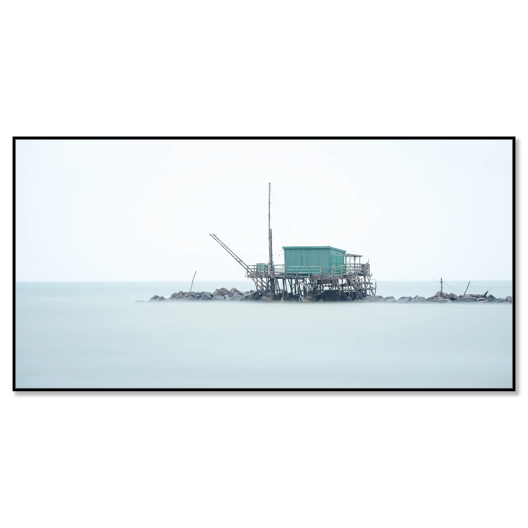 © 2024 Gerald Berghammer - Color minimalist photography. A small house built on stilts over water on rocks, with a fishing pole, in a minimalist, misty seascape. Chromaluxe framed black