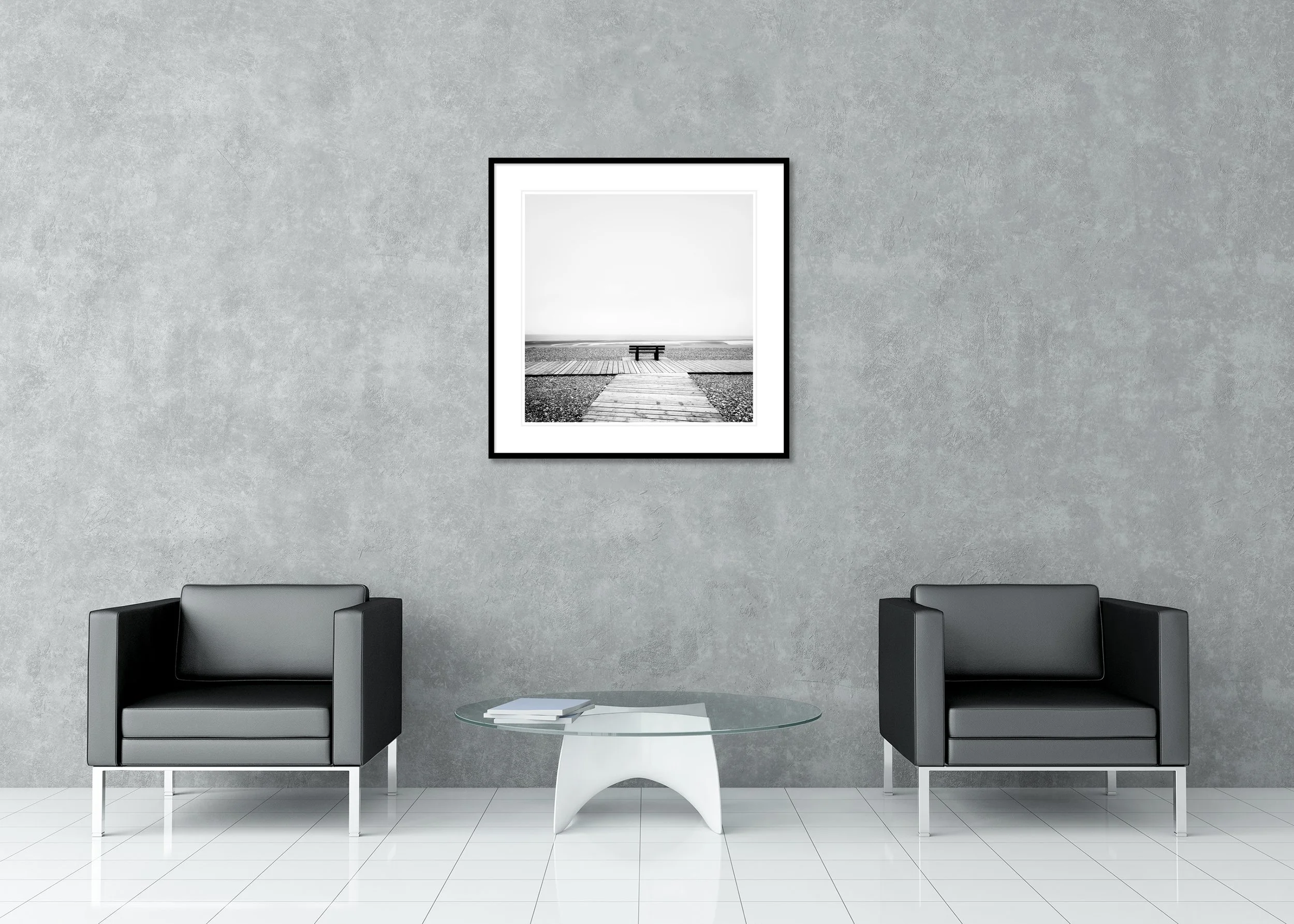 Black-and-white seascape with a bench on a wooden path overlooking the Atlantic Ocean and rocky beach, archival pigment print in a classic frame with a mount.