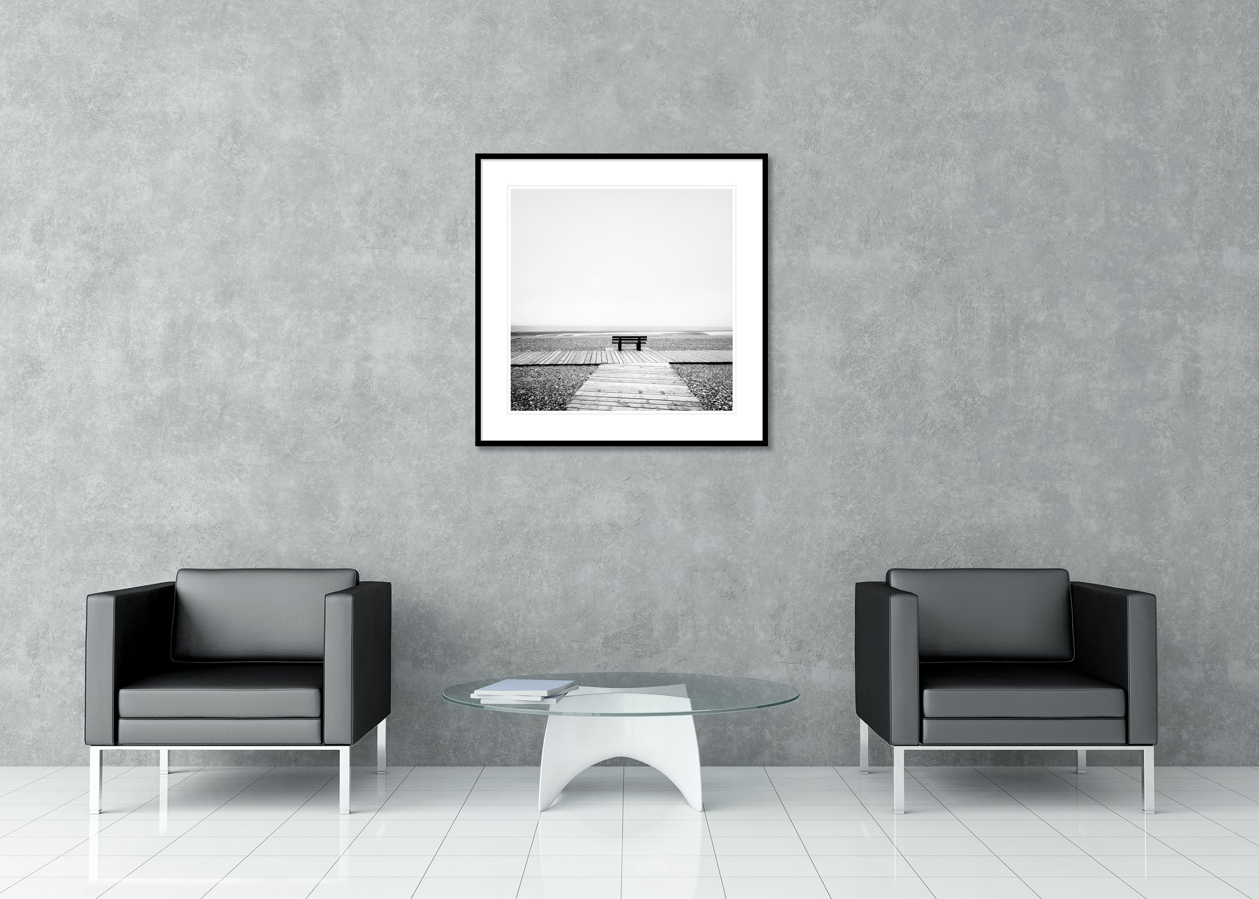 Black-and-white seascape with a bench on a wooden path overlooking the Atlantic Ocean and a rocky beach, archival pigment print in a classic frame with passe-partout