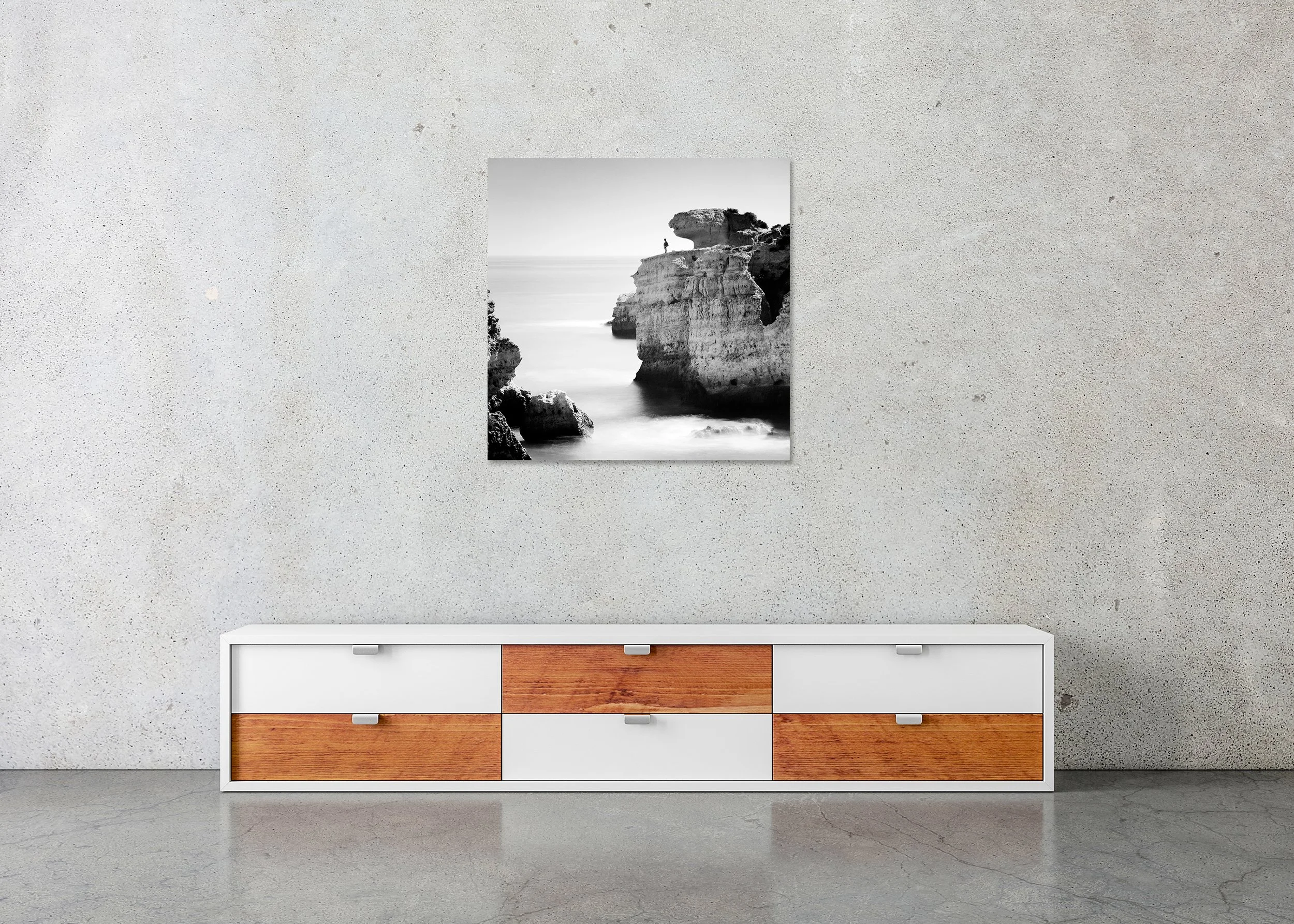 Rock Fishing Study 1 – frameless black-and-white photograph on aluminium Dibond displayed above a sideboard in a minimalist interior. Photo by Gerald Berghammer.