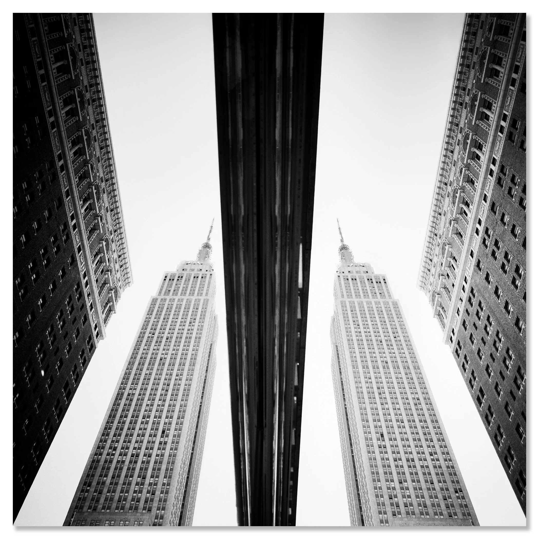 Low-angle black-and-white photograph of symmetrical skyscrapers in New York City – dibond frameless