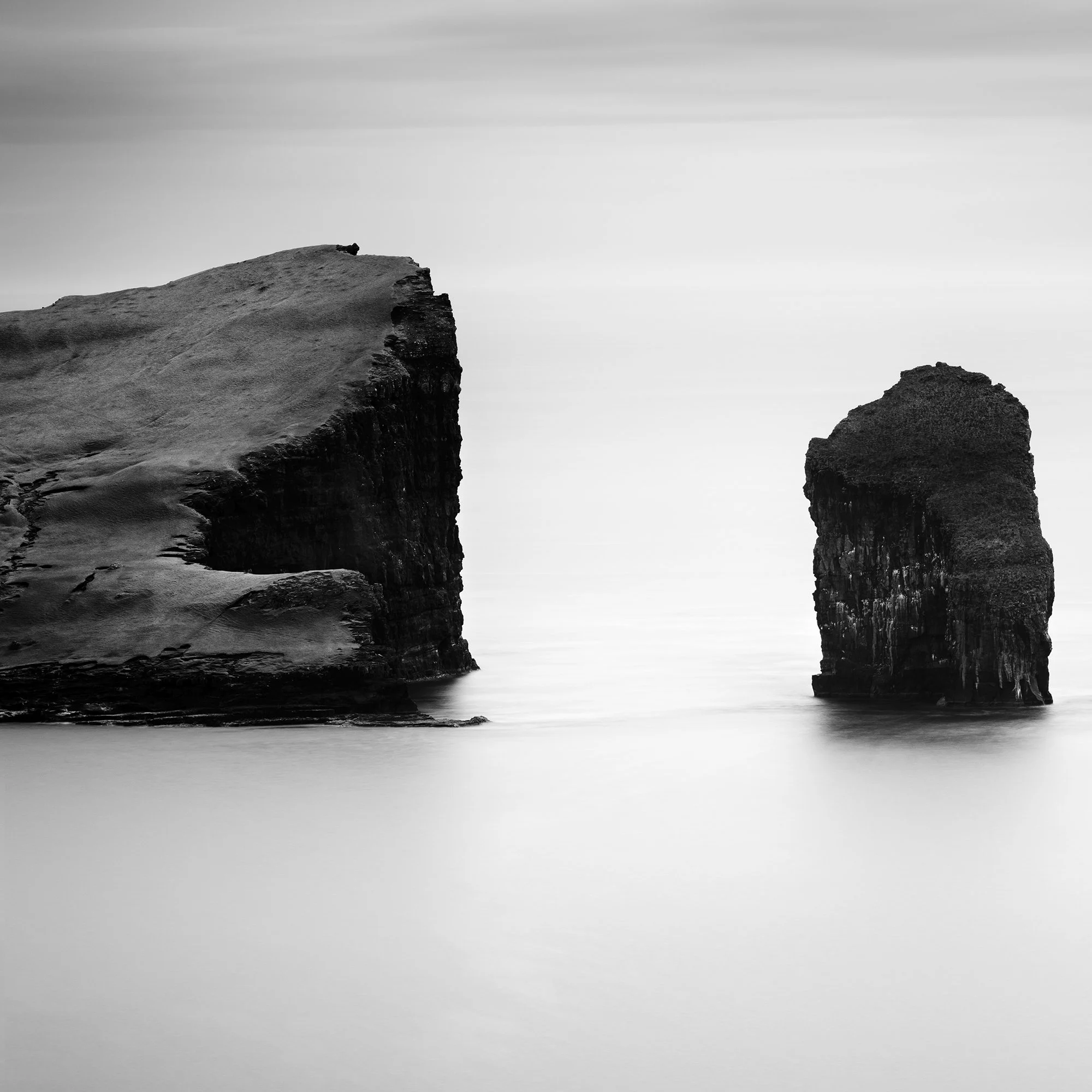 Close-up of North Atlantic Basalt Study 1 showing fine art print surface and tonal detail in the basalt sea stacks.