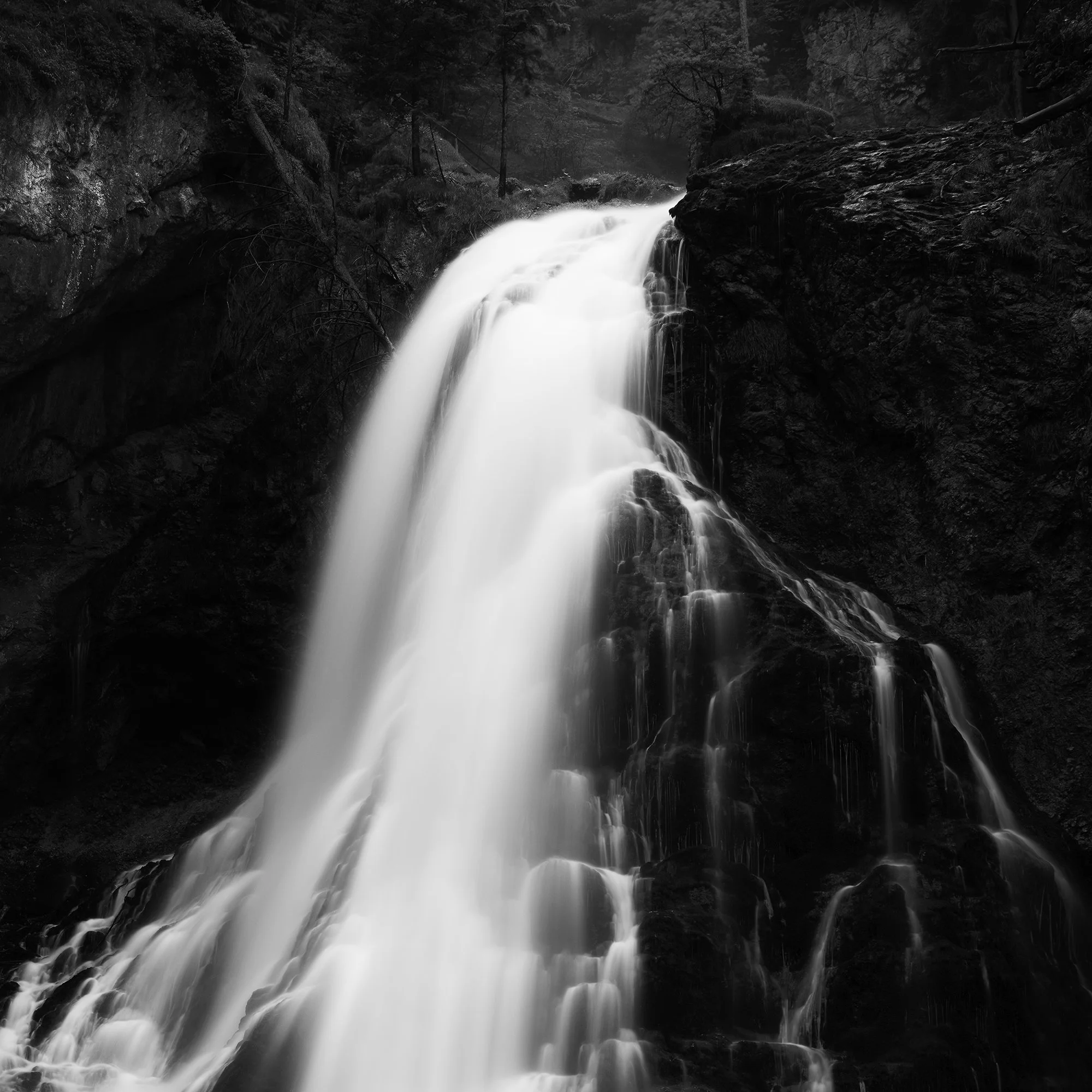 Black-and-white photograph of a waterfall cascading down a rocky cliff into a pool below, Detail 2