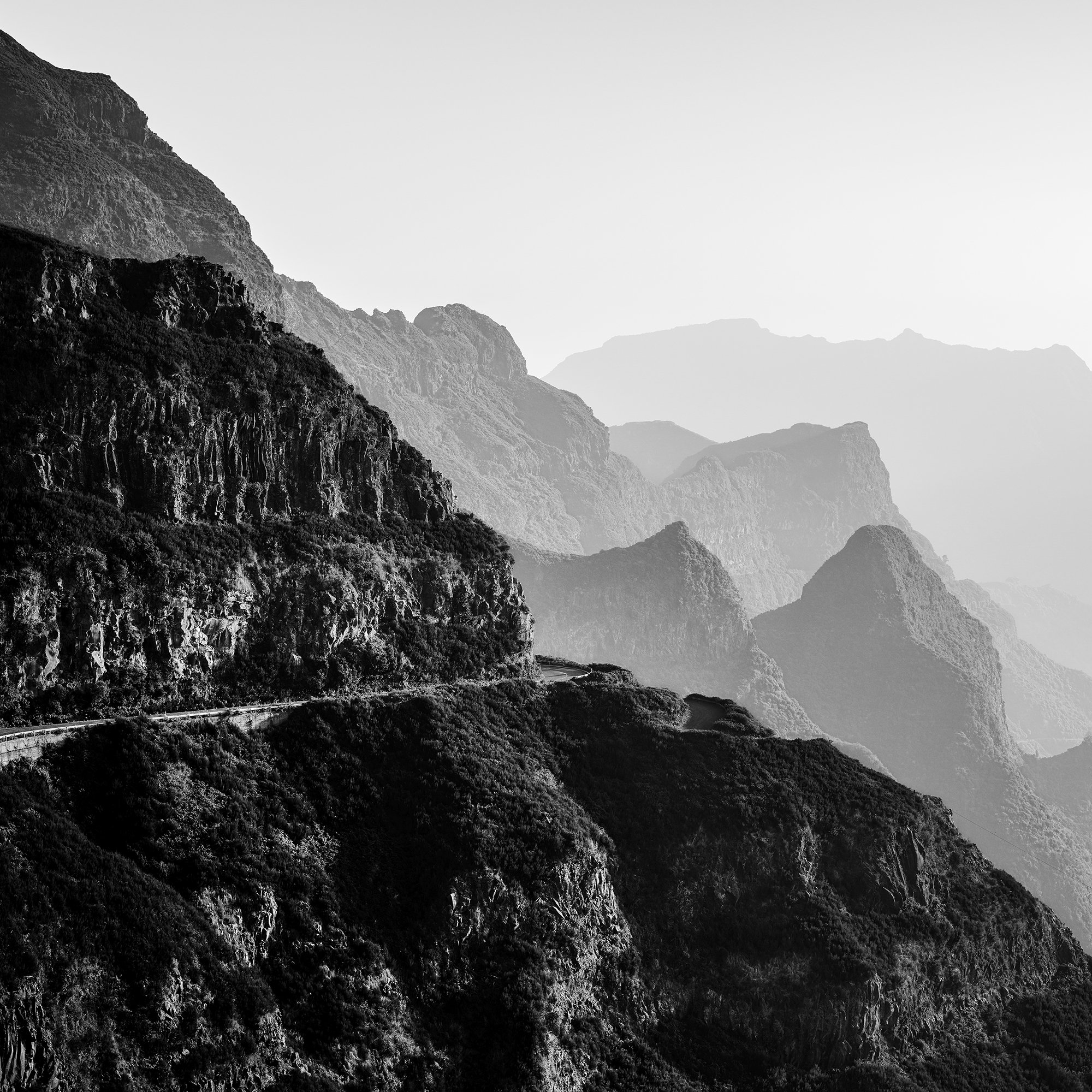Madeira Peaks Study 1 by Gerald Berghammer, black-and-white detail of rugged cliffs and a narrow mountain road in Madeira.