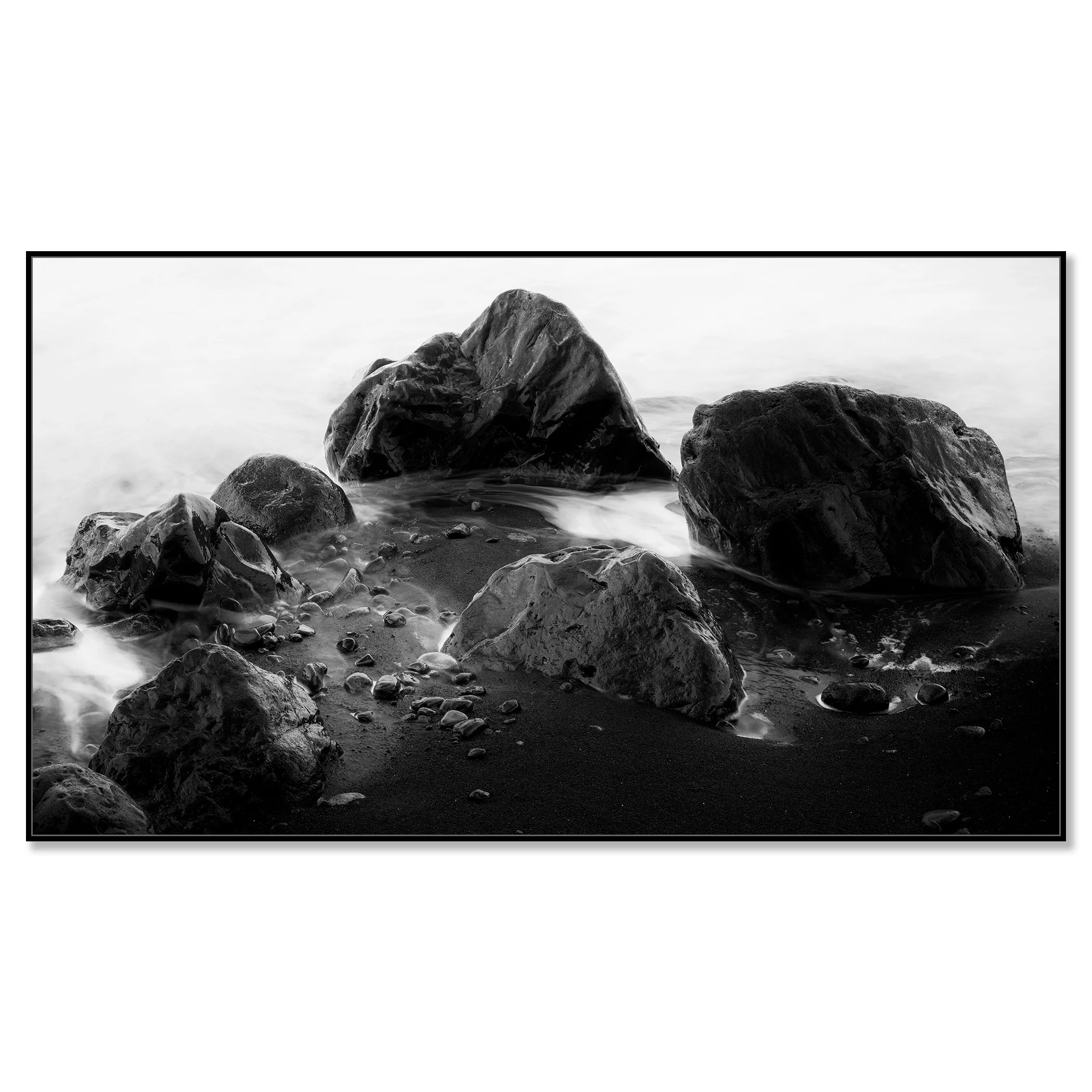 Black and white long exposure photo of sea rocks on a sandy beach with gentle surf – framed ArtBox black