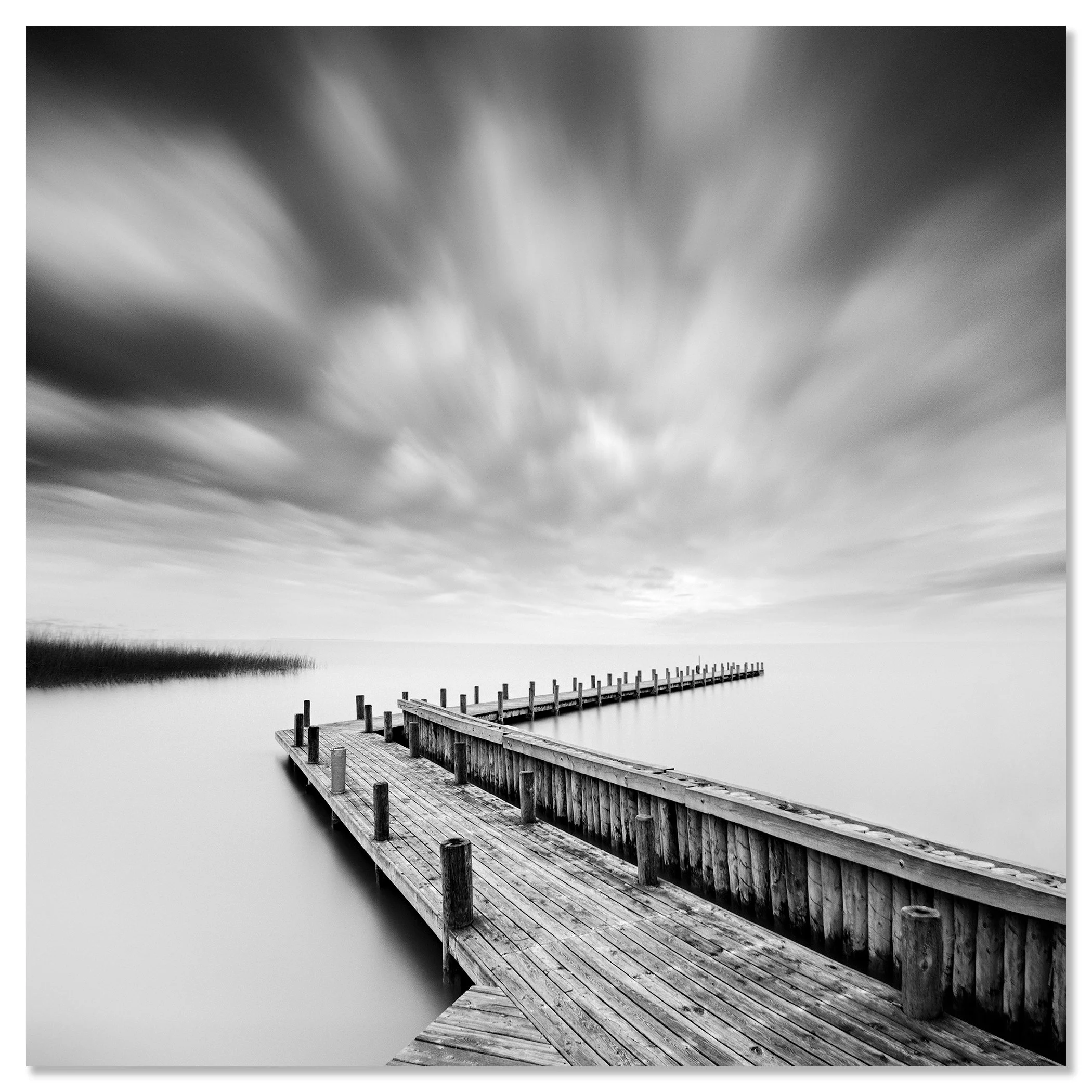 Fine art black and white seascape with an old wooden pier, calm water and dramatic long exposure sky – dibond frameless