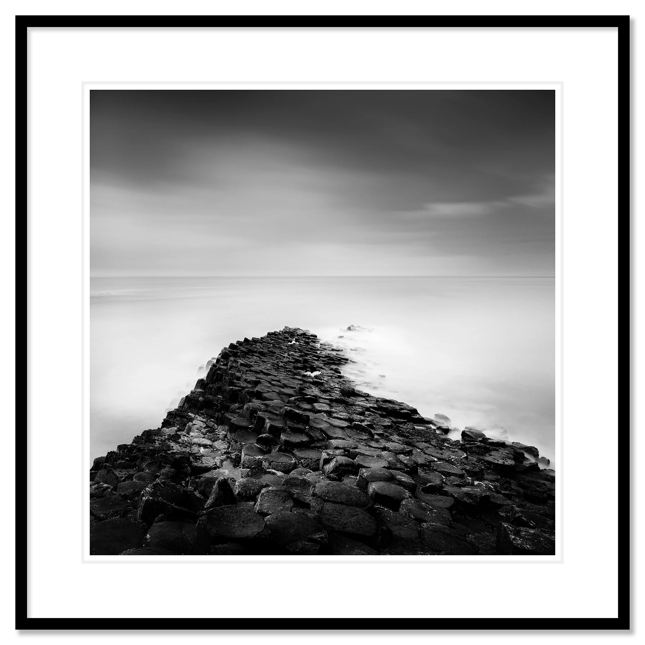 Giant’s Causeway Study 2 shown in a black aluminium frame with a white mount by Gerald Berghammer.