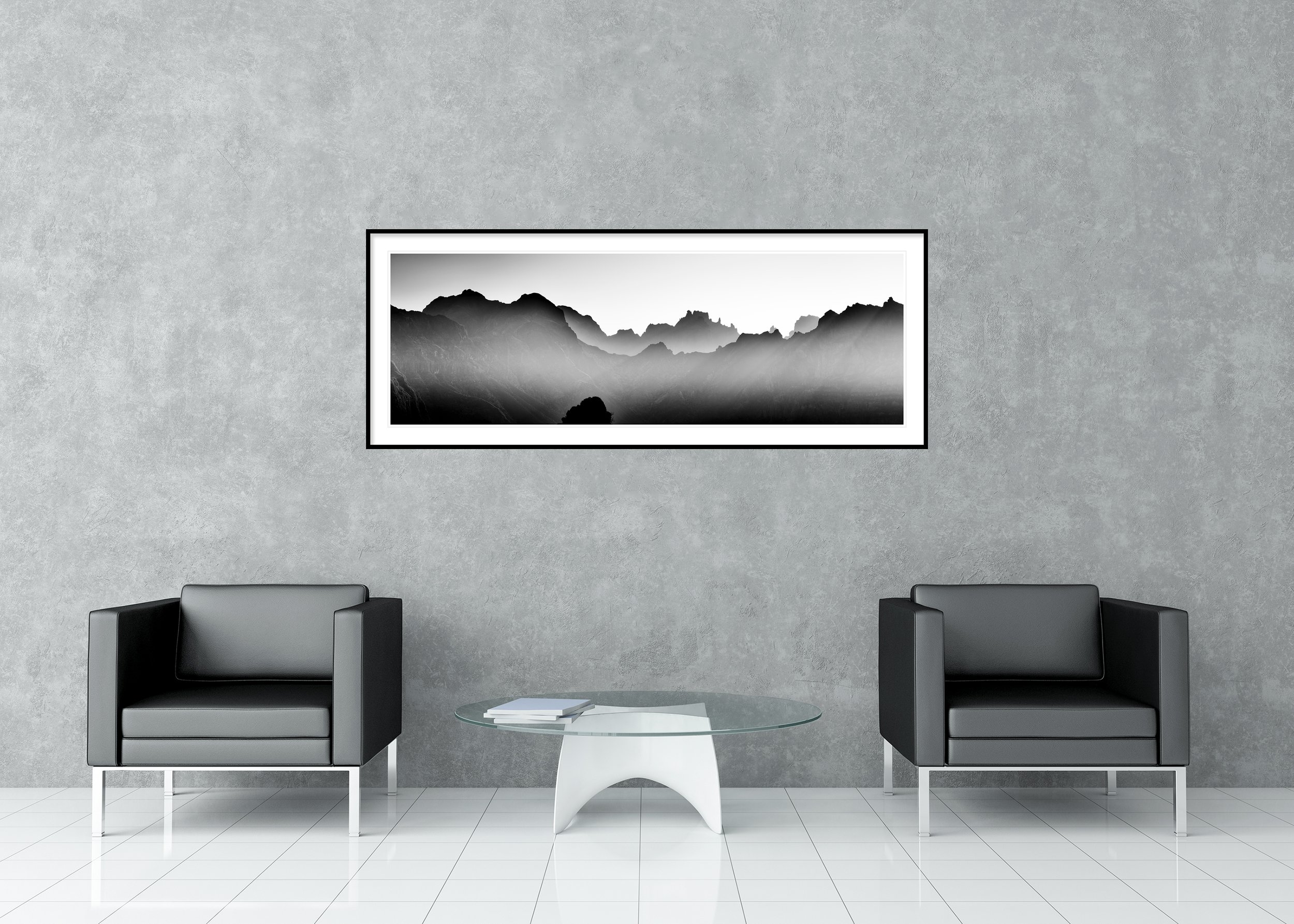 Mountains in Shadow with Morning Light by Gerald Berghammer displayed in a contemporary interior in a black aluminium frame with a white mount.