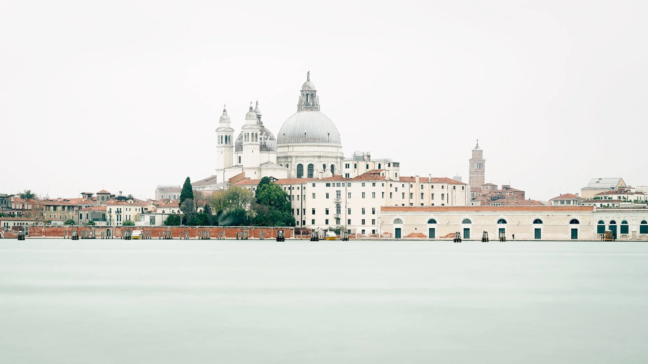 Santa Maria della Salute and the historic Venetian waterfront across the calm lagoon in Venice, Italy. Photo by Gerald Berghammer.